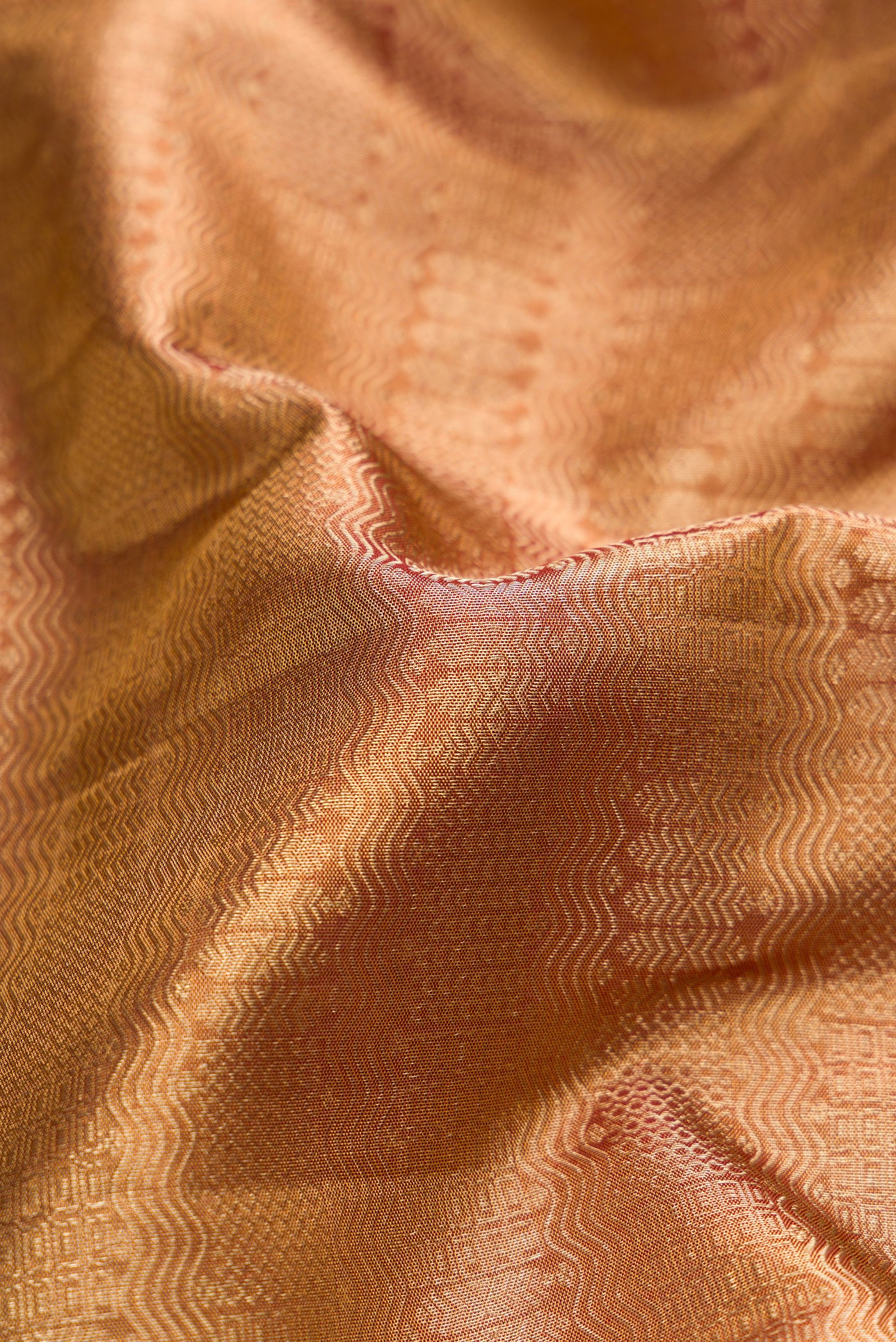 Close up of Gold Dual Tone Kanjivaram Tissue Silk Saree with Zari Brocade on the body and Zari Border.  displaying folds