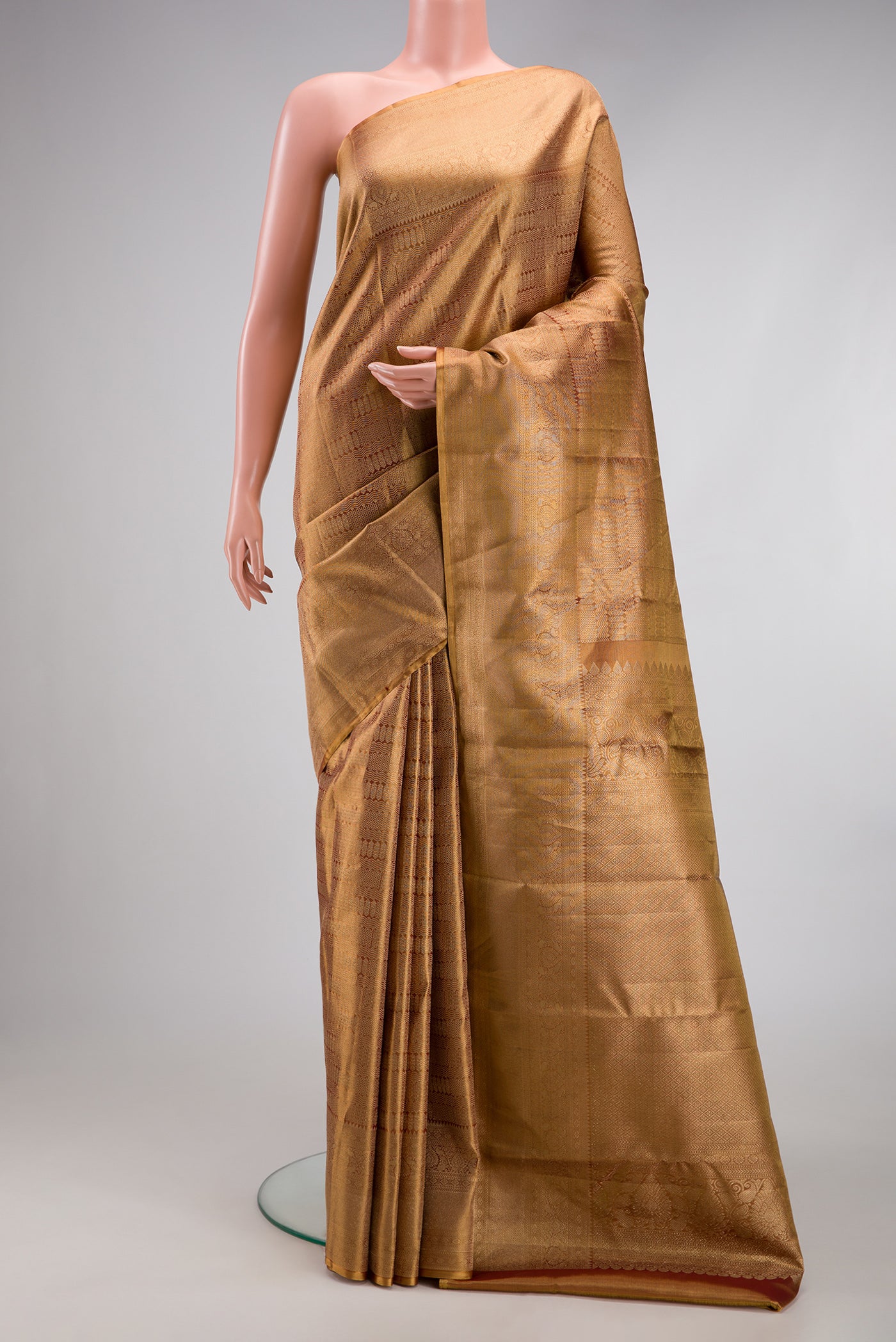 Gold Dual Tone Kanjivaram Tissue Silk Saree with Zari Brocade on the body and Zari Border.  displayed on a mannequin