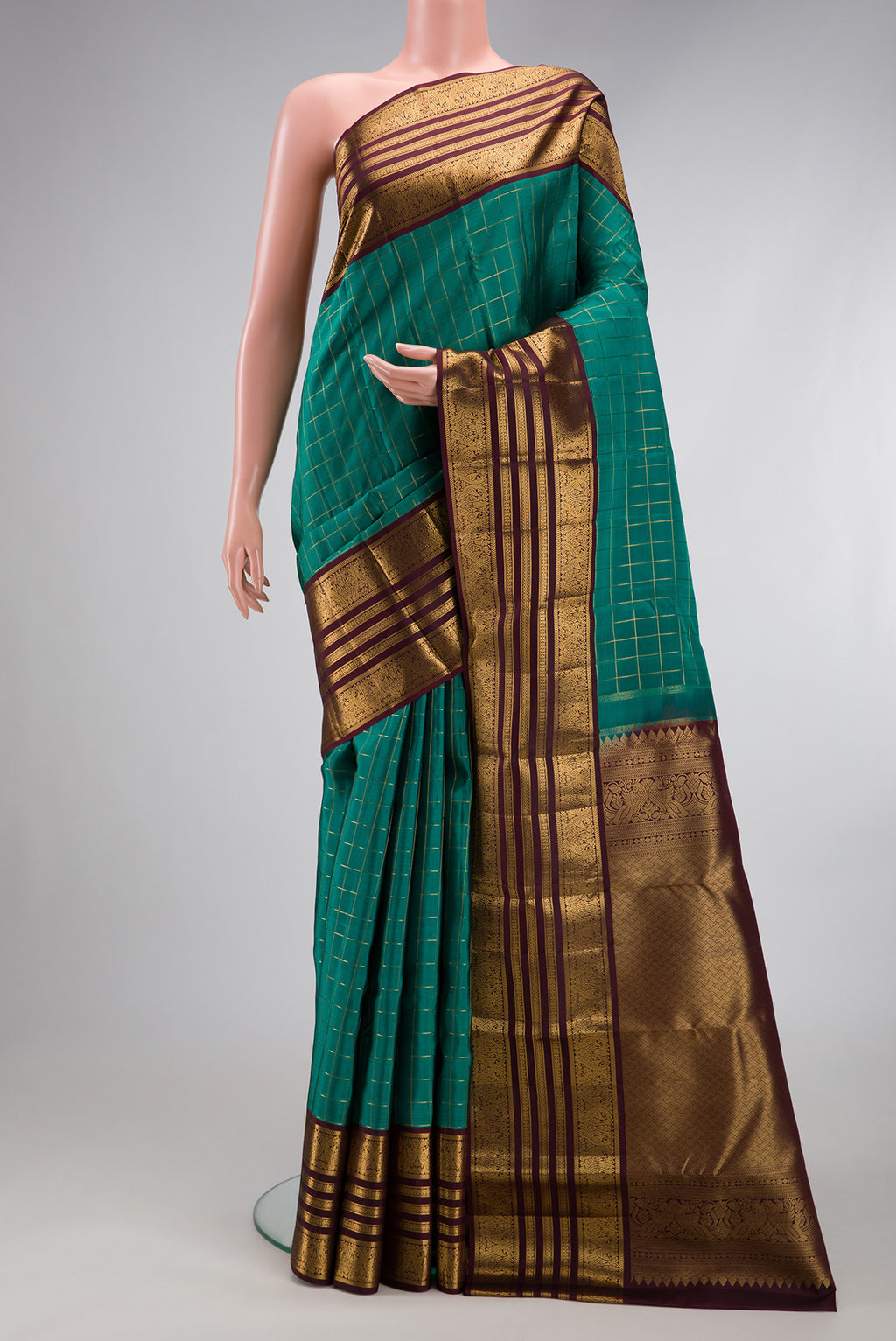 Teal Kanjivaram Silk Saree with Checked design on the body and Zari Border.  displayed on a mannequin