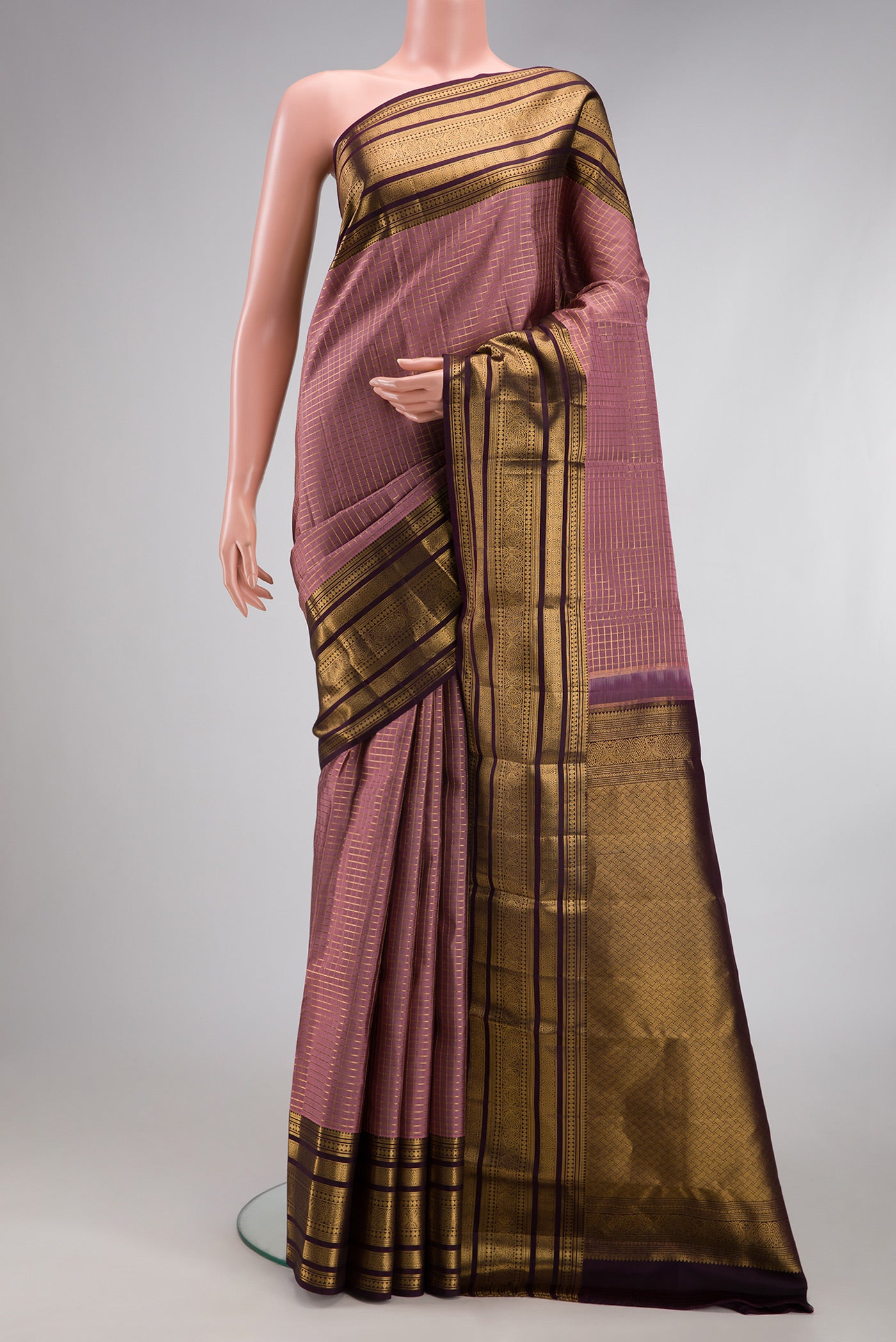 Mauve Kanjivaram Silk Saree with Checked design on the body and Zari Border.  displayed on a mannequin