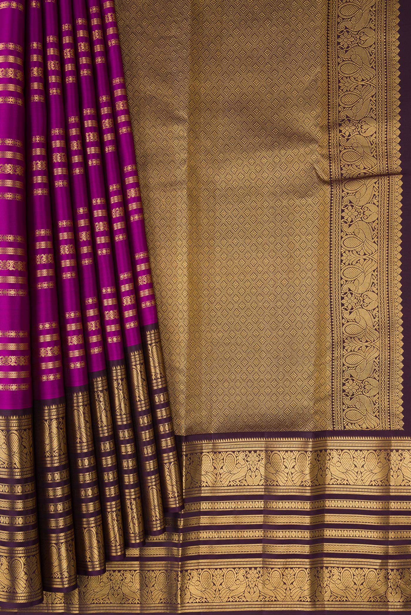 Pleats and pallu of Magenta Kanjivaram Silk Saree with Stripes on the body and Zari Border. 