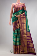 Green Kanjivaram Silk Saree with Stripes on the body and Zari Border.  displayed on a mannequin