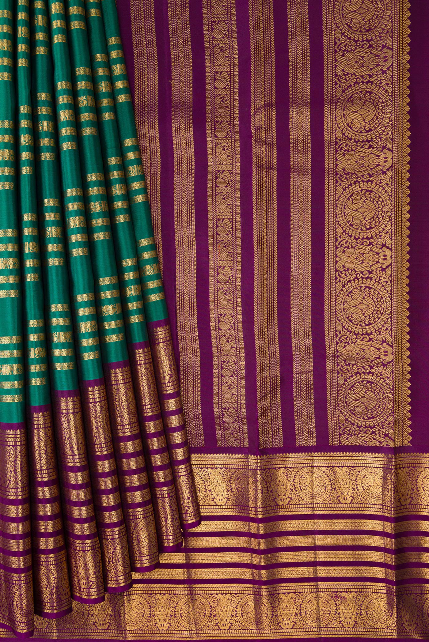 Pleats and pallu of Green Kanjivaram Silk Saree with Stripes on the body and Zari Border. 