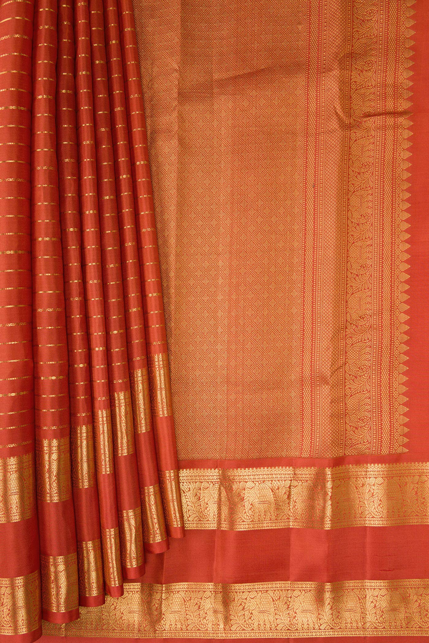 Pleats and pallu of Brick Orange Kanjivaram Silk Saree with Stripes on the body and Zari Border. 