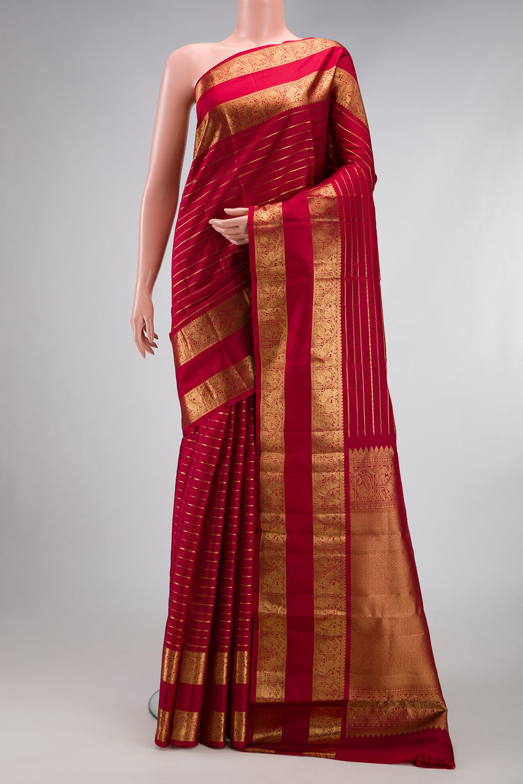 Maroon Kanjivaram Silk Saree with Stripes on the body and Zari Border.  displayed on a mannequin