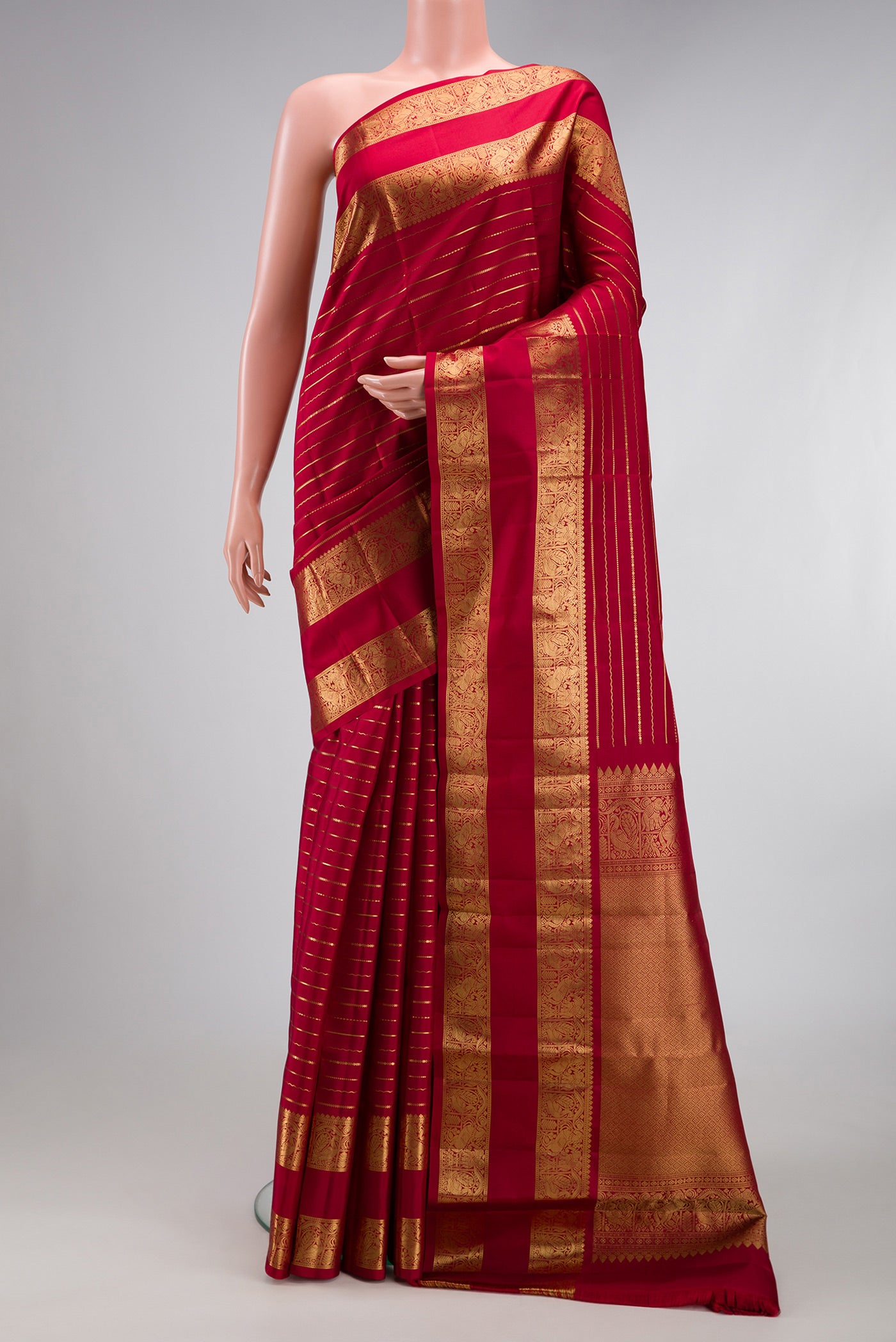 Maroon Kanjivaram Silk Saree with Stripes on the body and Zari Border.  displayed on a mannequin