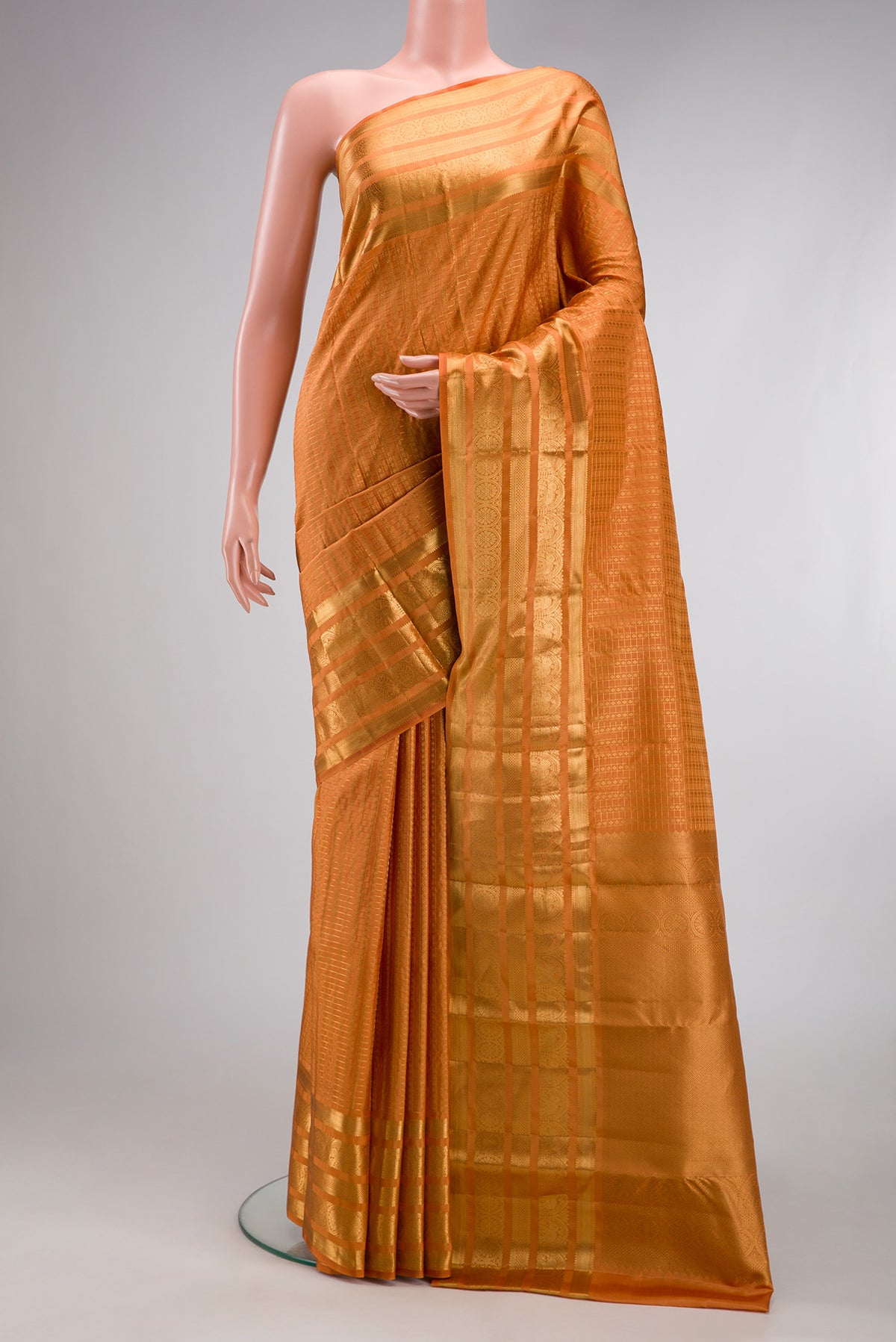 Orange Kanjivaram Silk Saree with Zari Brocade on the body and Zari Border.  displayed on a mannequin