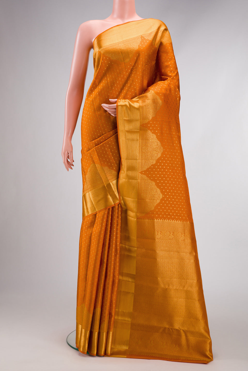 Orange Dual Tone Kanjivaram Silk Saree with Zari Butta on the body and Fancy Border.  displayed on a mannequin