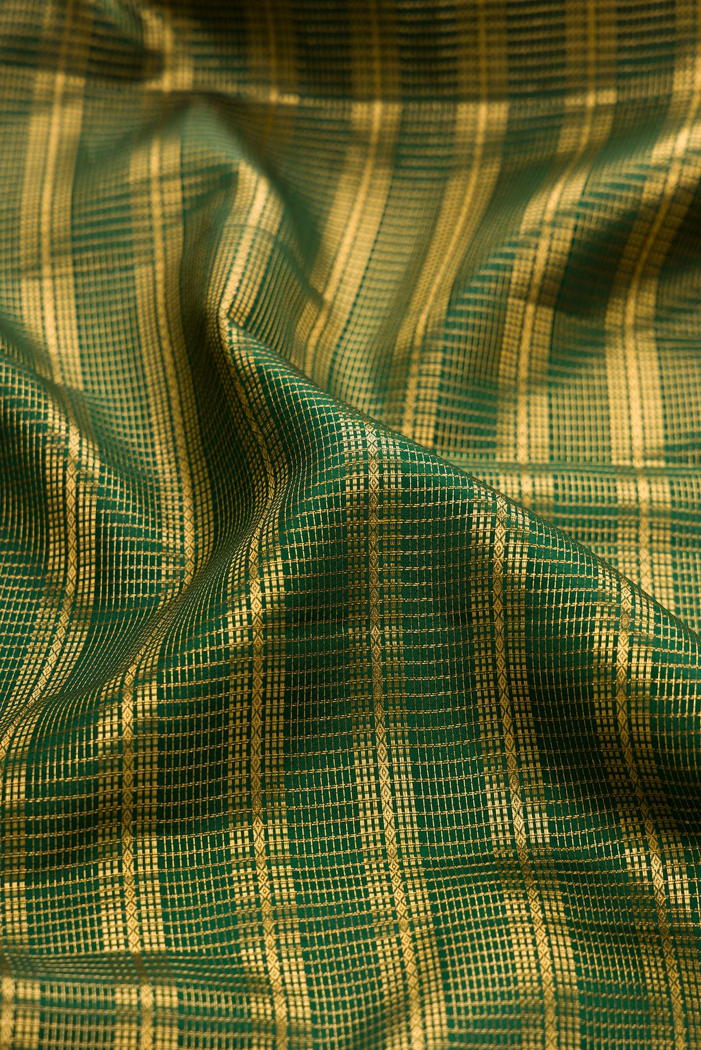 Close up of Bottle Green Kanjivaram Silk Saree with Stripes on the body and Zari Border.  displaying folds