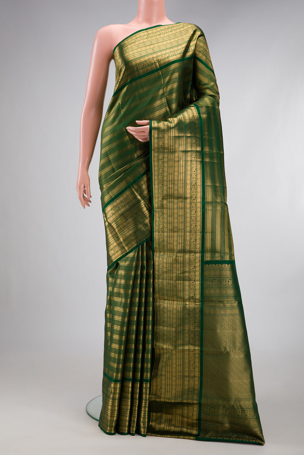 Bottle Green Kanjivaram Silk Saree with Stripes on the body and Zari Border.  displayed on a mannequin
