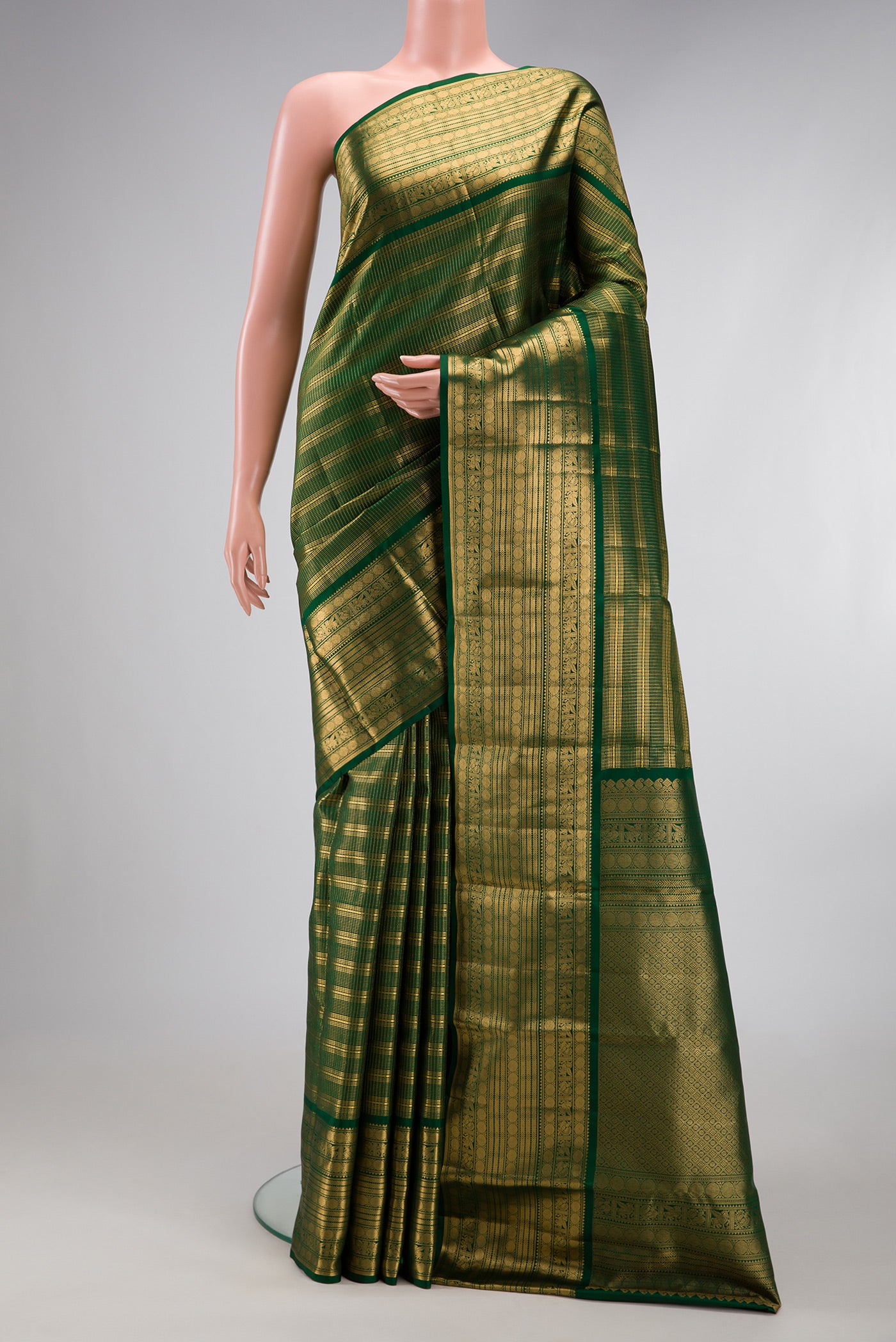 Bottle Green Kanjivaram Silk Saree with Stripes on the body and Zari Border.  displayed on a mannequin