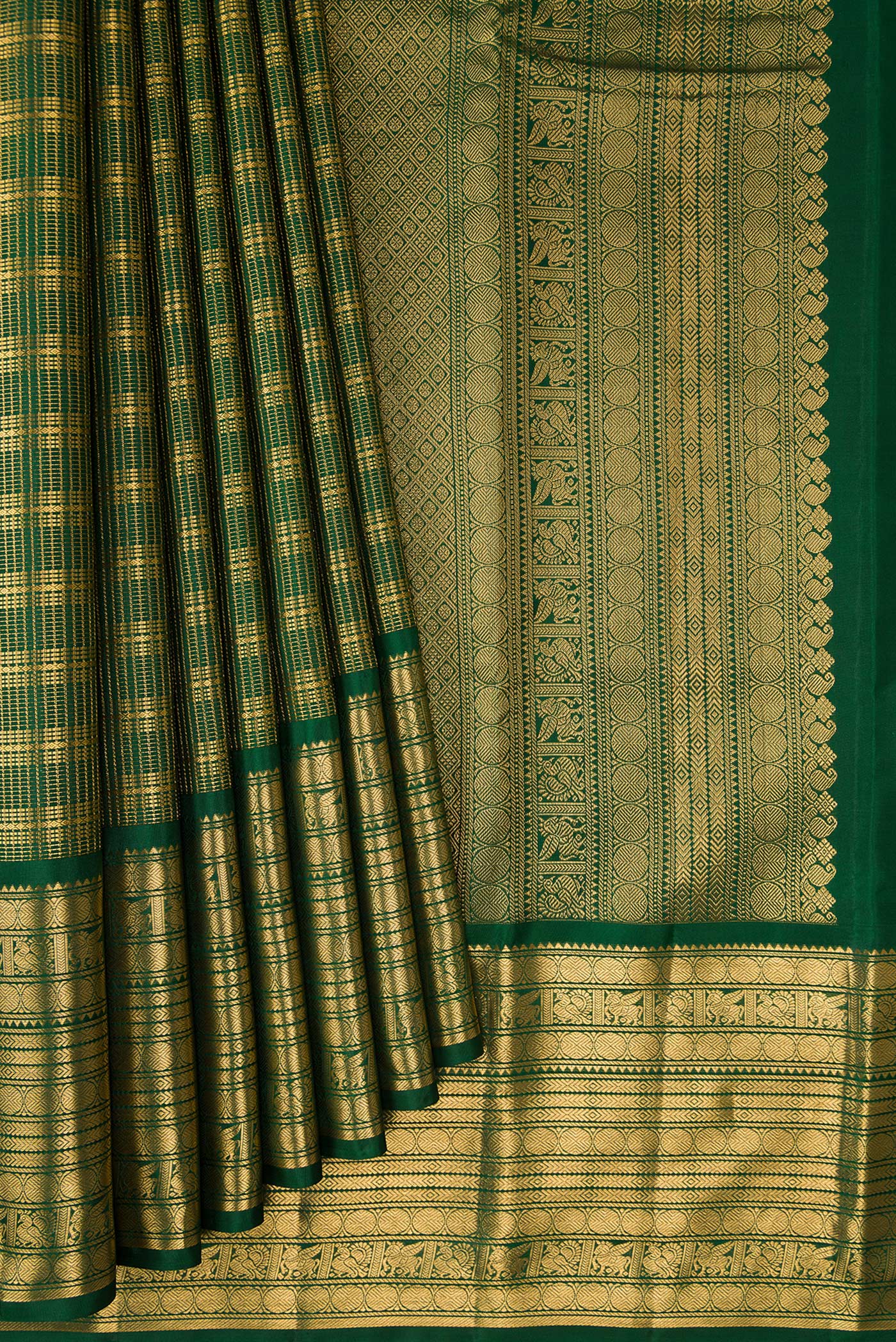 Pleats and pallu of Bottle Green Kanjivaram Silk Saree with Stripes on the body and Zari Border. 
