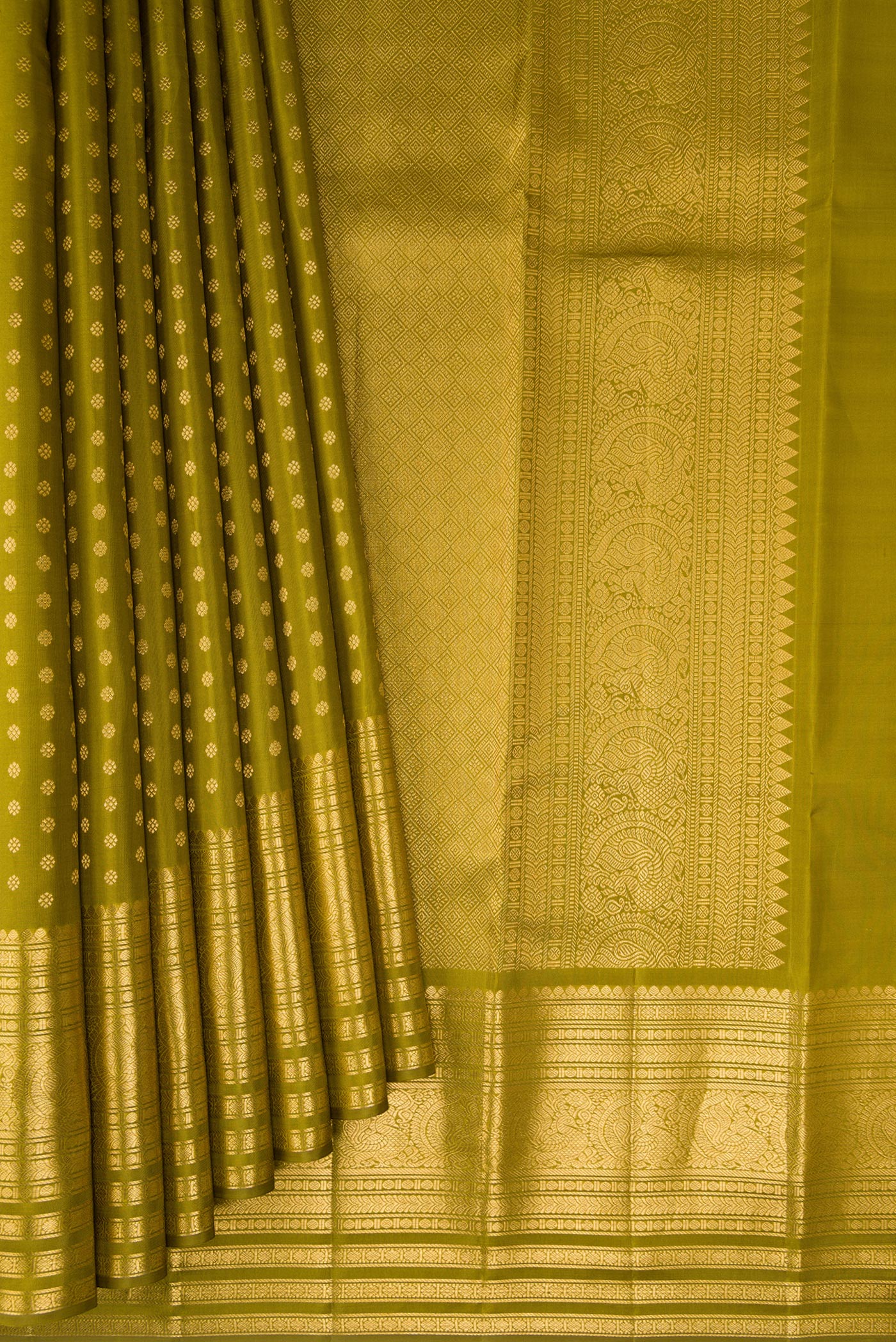 Pleats and pallu of Mehandi Green Kanchipuram Silk Saree with Zari Butta on the body and Zari Border. 