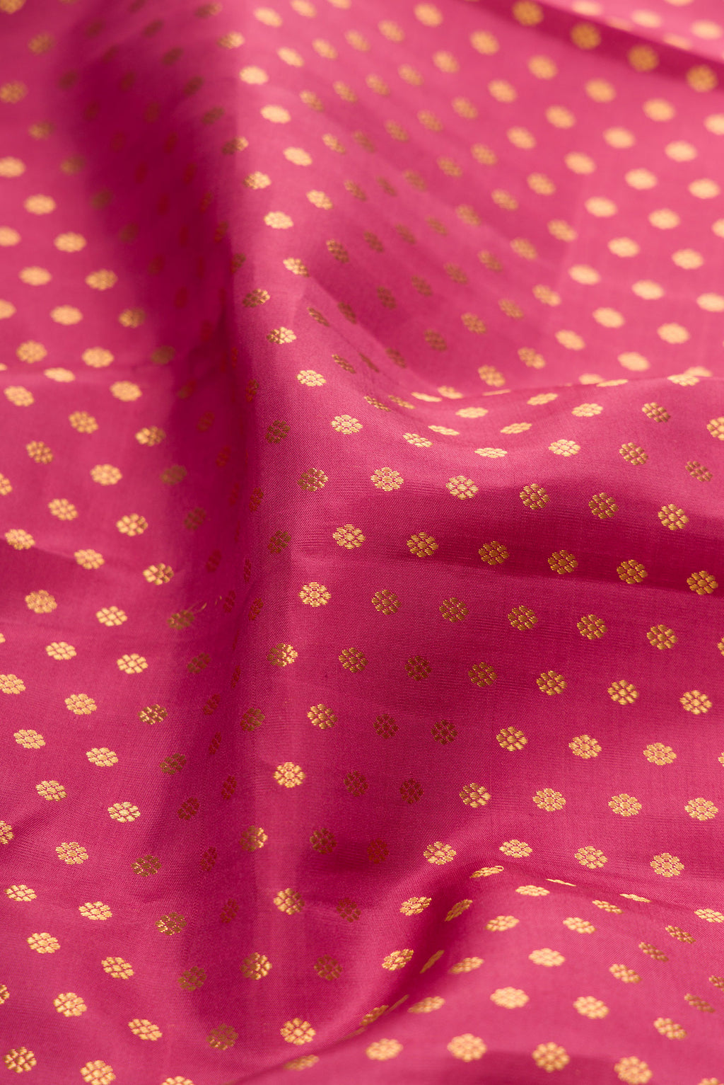 Close up of Rose pink Kanchipuram Silk Saree with Zari Butta on the body and Zari Border.  displaying folds