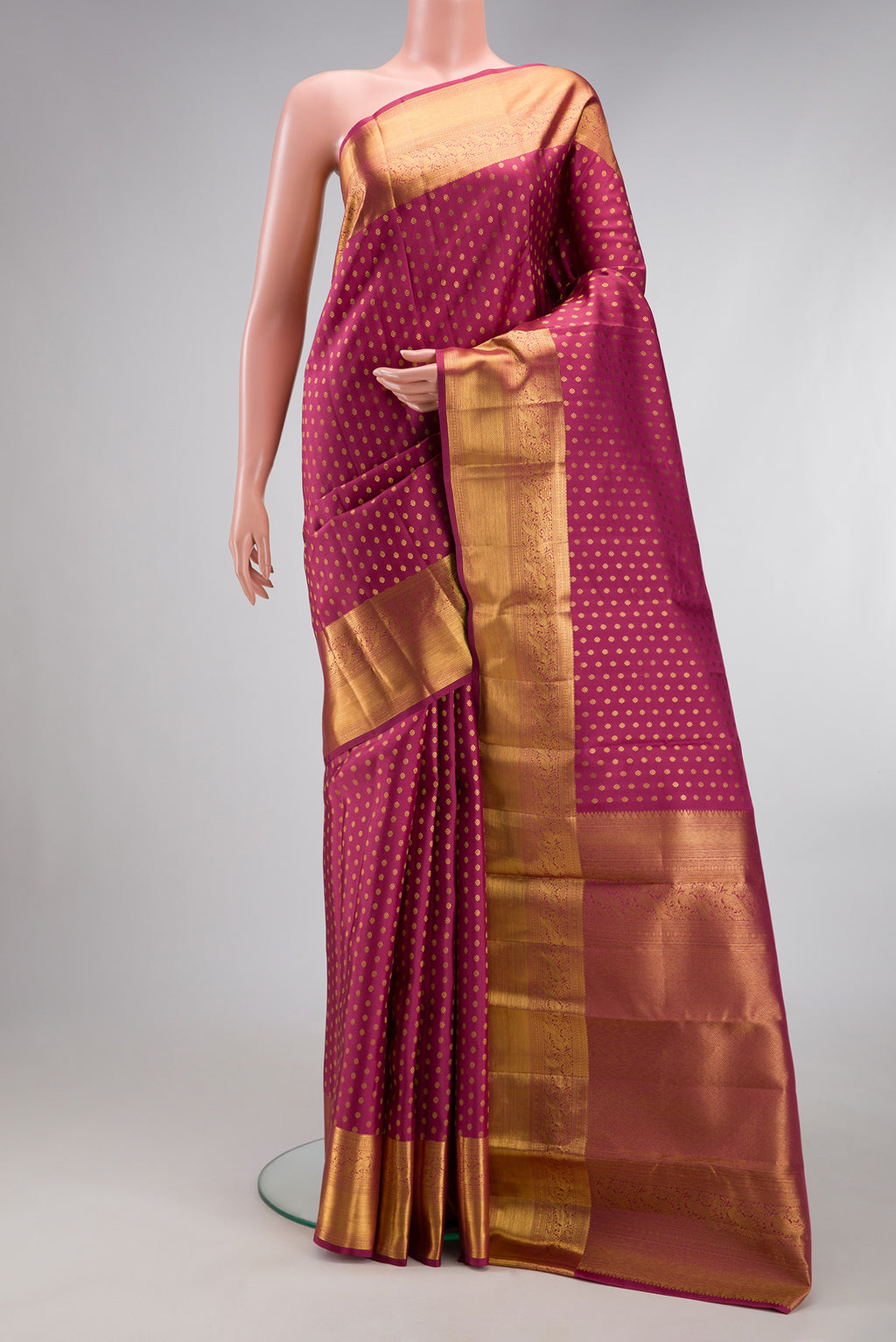 Rose pink Kanchipuram Silk Saree with Zari Butta on the body and Zari Border.  displayed on a mannequin