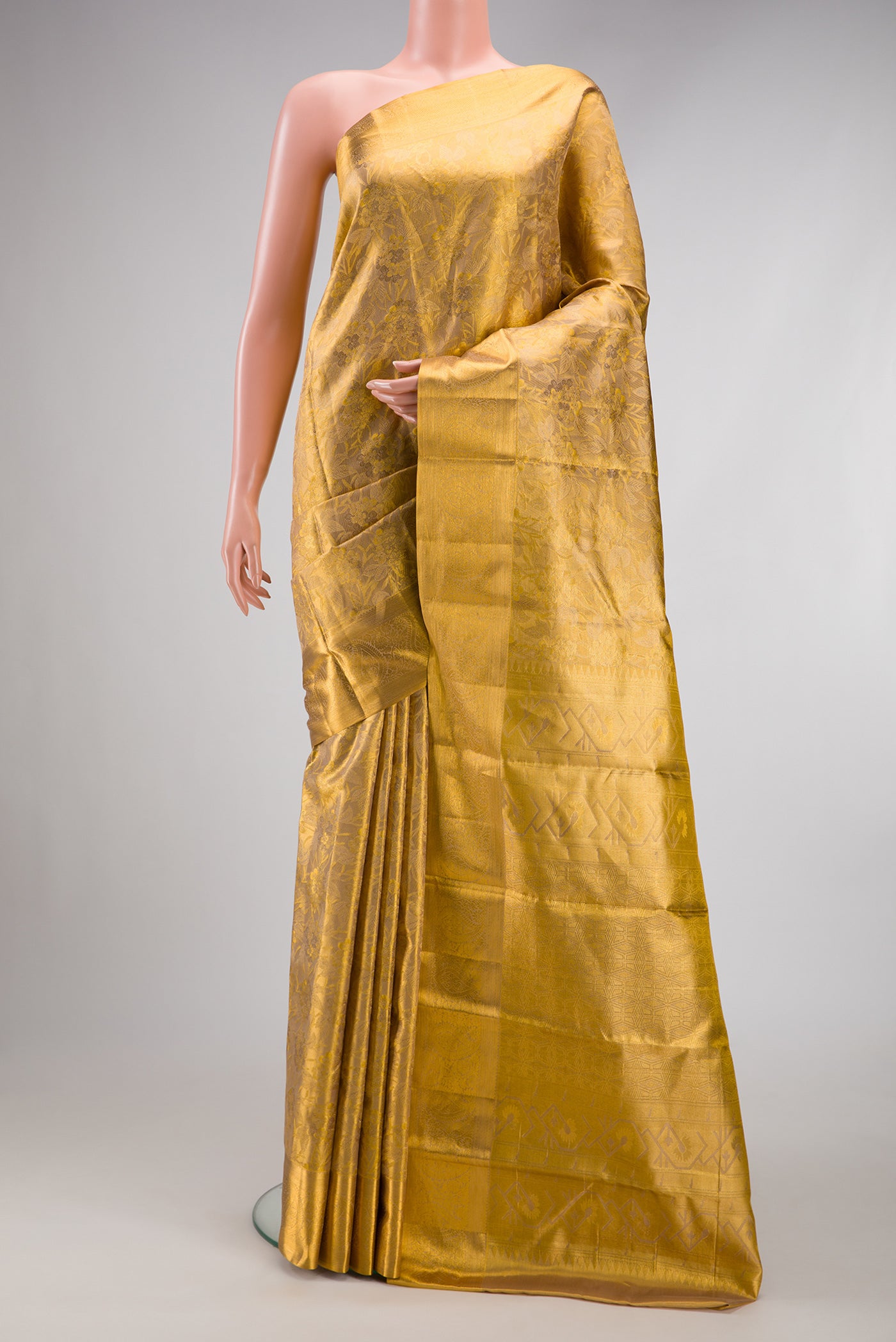 Gold Dual Tone Kanchipuram Tissue Silk Saree with Zari Brocade on the body and Zari Border.  displayed on a mannequin