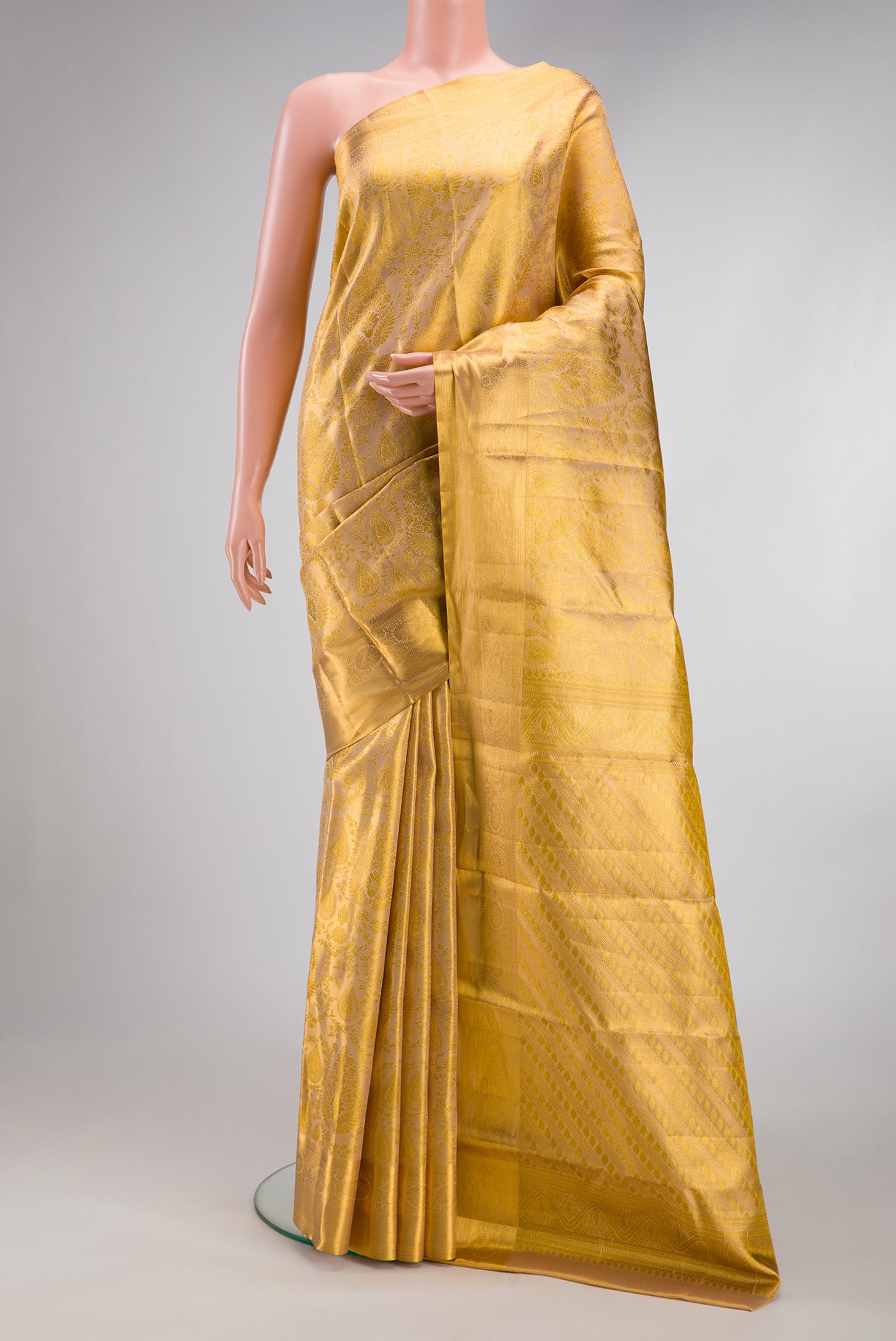 Gold Dual Tone Kanchipuram Tissue Silk Saree with Zari Brocade on the body and Zari Border.  displayed on a mannequin