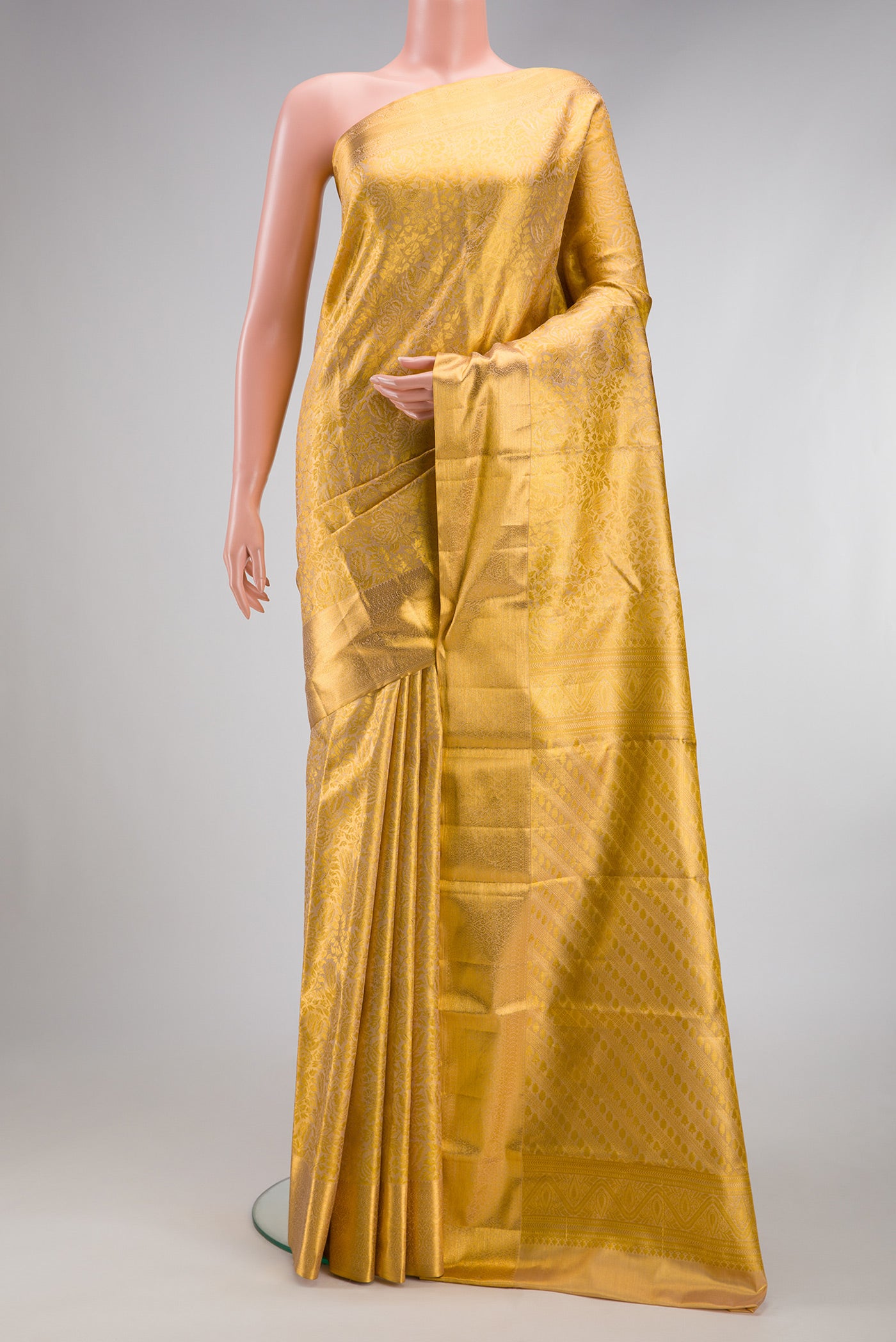 Gold Dual Tone Kanchipuram Tissue Silk Saree with Zari Brocade on the body and Zari Border.  displayed on a mannequin