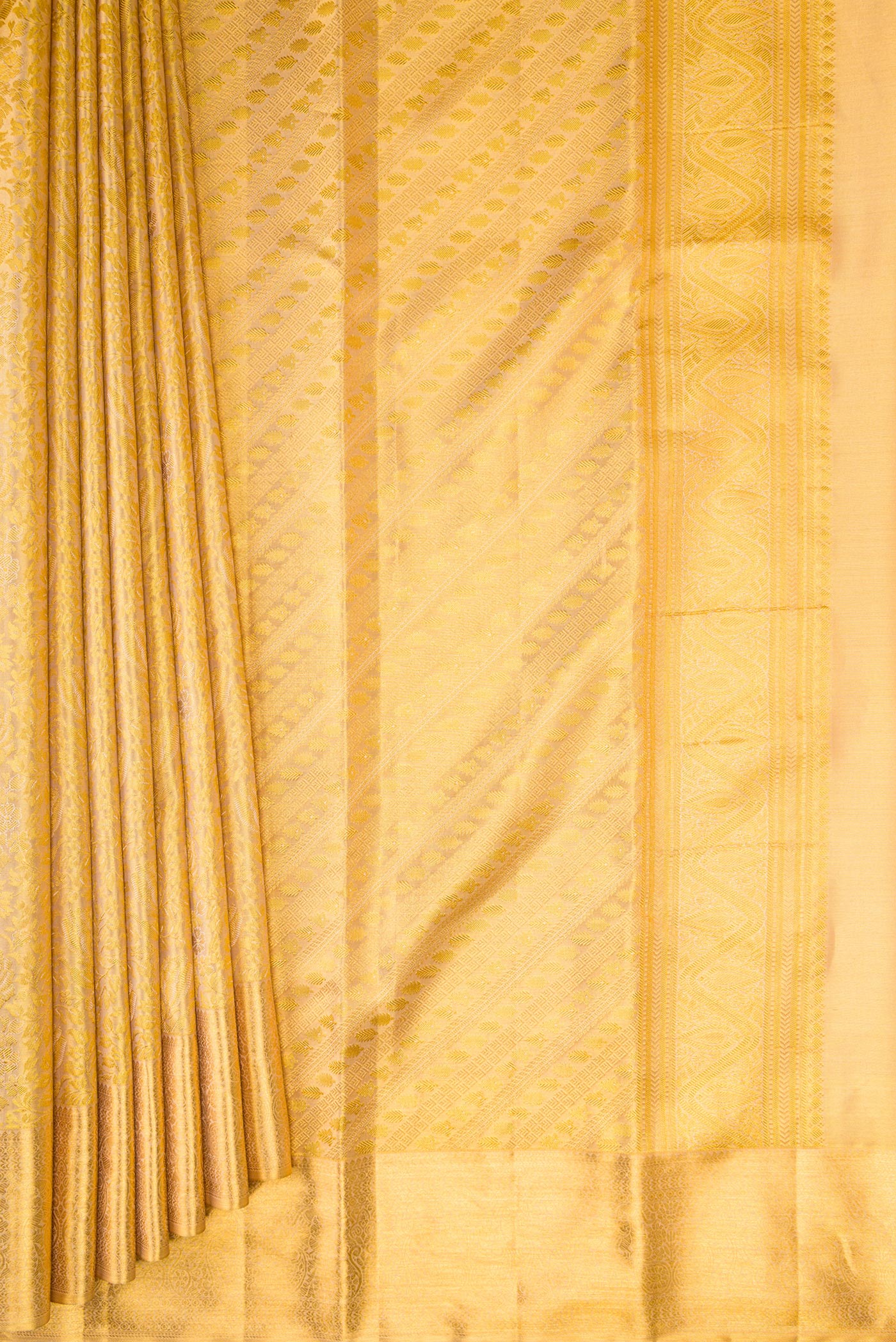 Pleats and pallu of Gold Dual Tone Kanchipuram Tissue Silk Saree with Zari Brocade on the body and Zari Border. 
