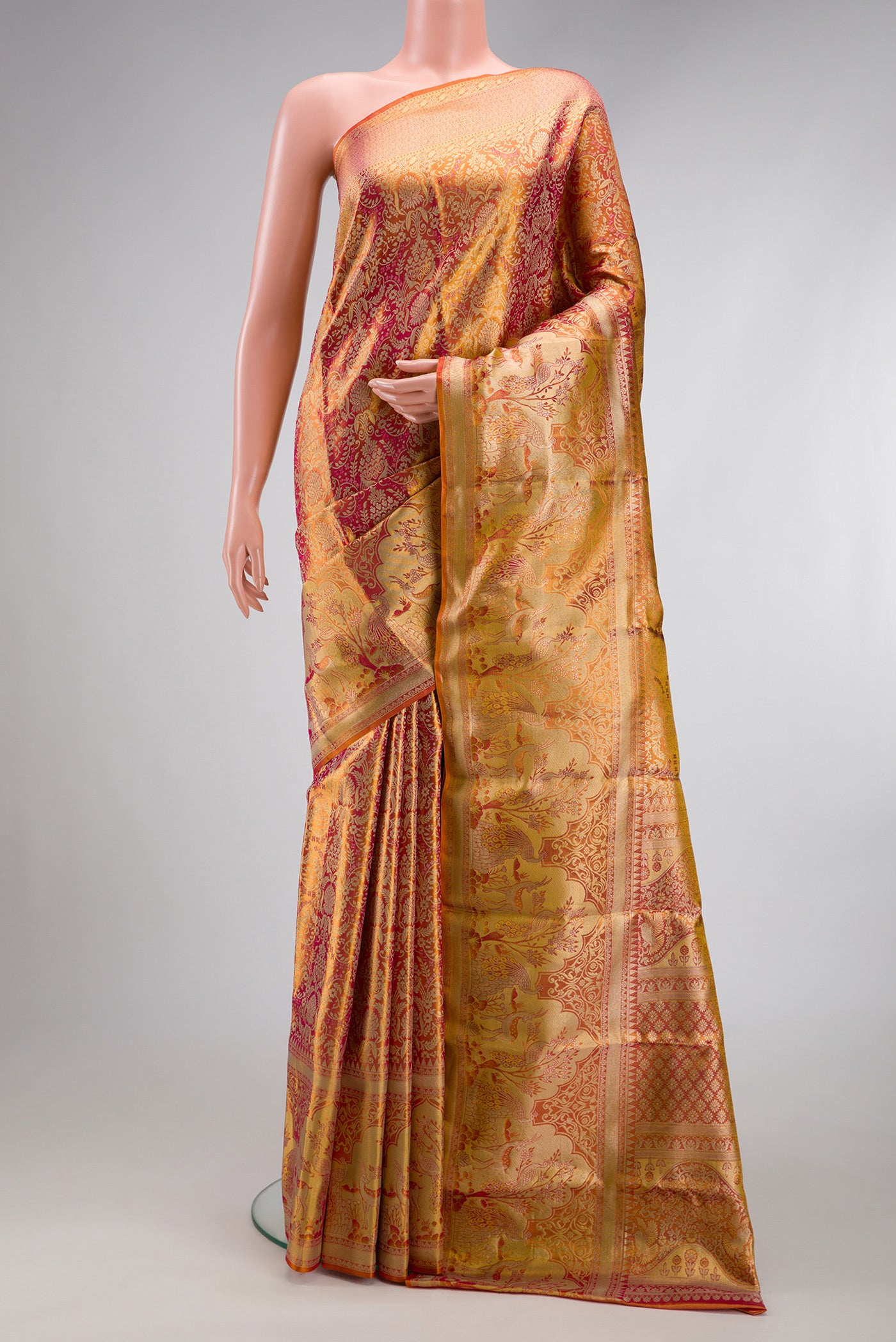 Coral Dual Tone Kanjivaram Tissue Silk Saree with Zari Brocade on the body and Fancy Border.  displayed on a mannequin
