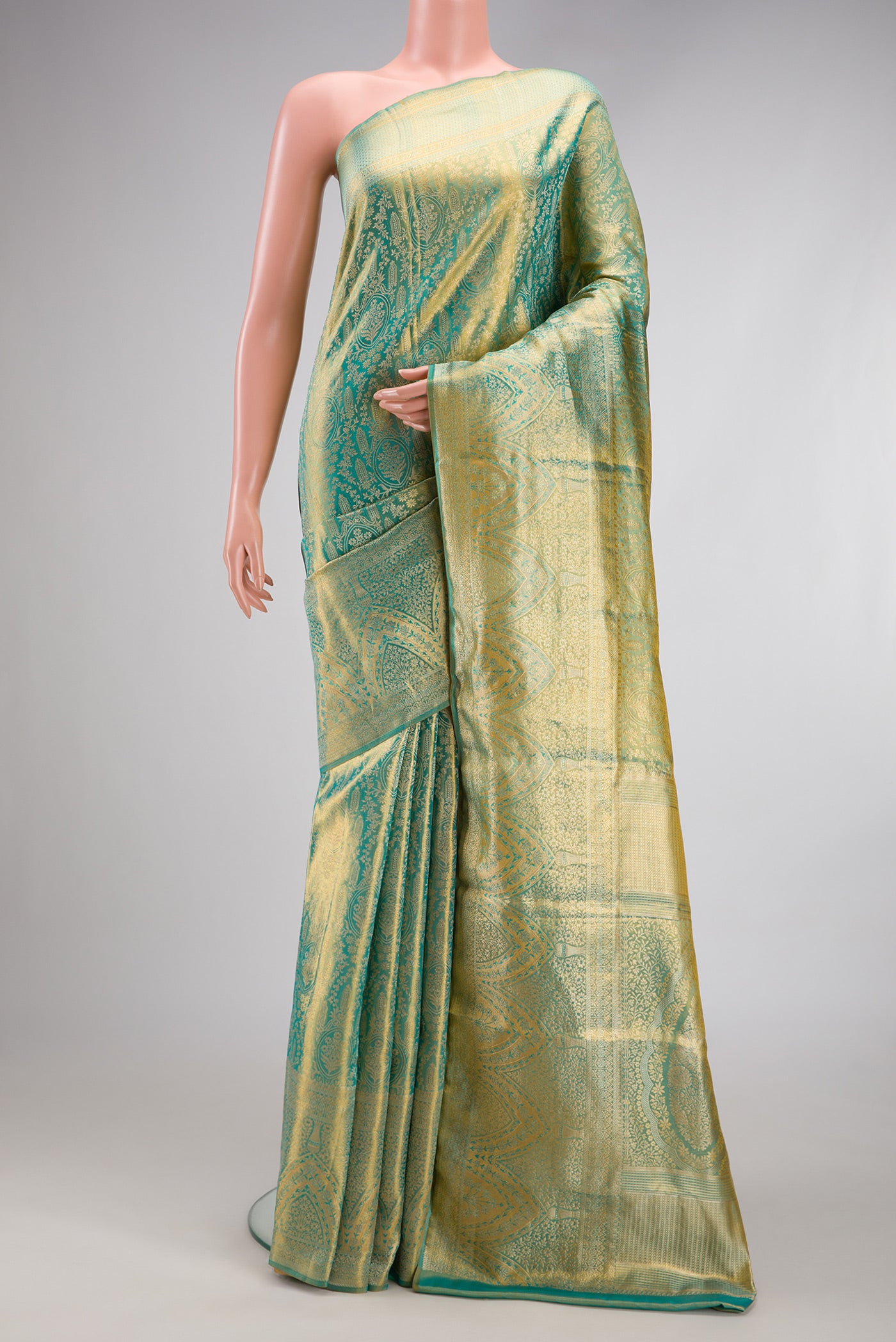 Sea Green Dual Tone Kanjivaram Tissue Silk Saree with Zari Brocade on the body and Fancy Border.  displayed on a mannequin