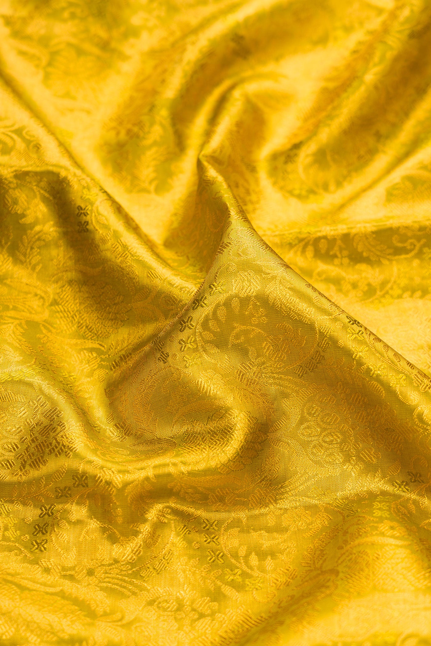 Close up of Mehandi Green Dual Tone Kanjivaram Tissue Silk Saree with Zari Brocade on the body and Fancy Border.  displaying folds