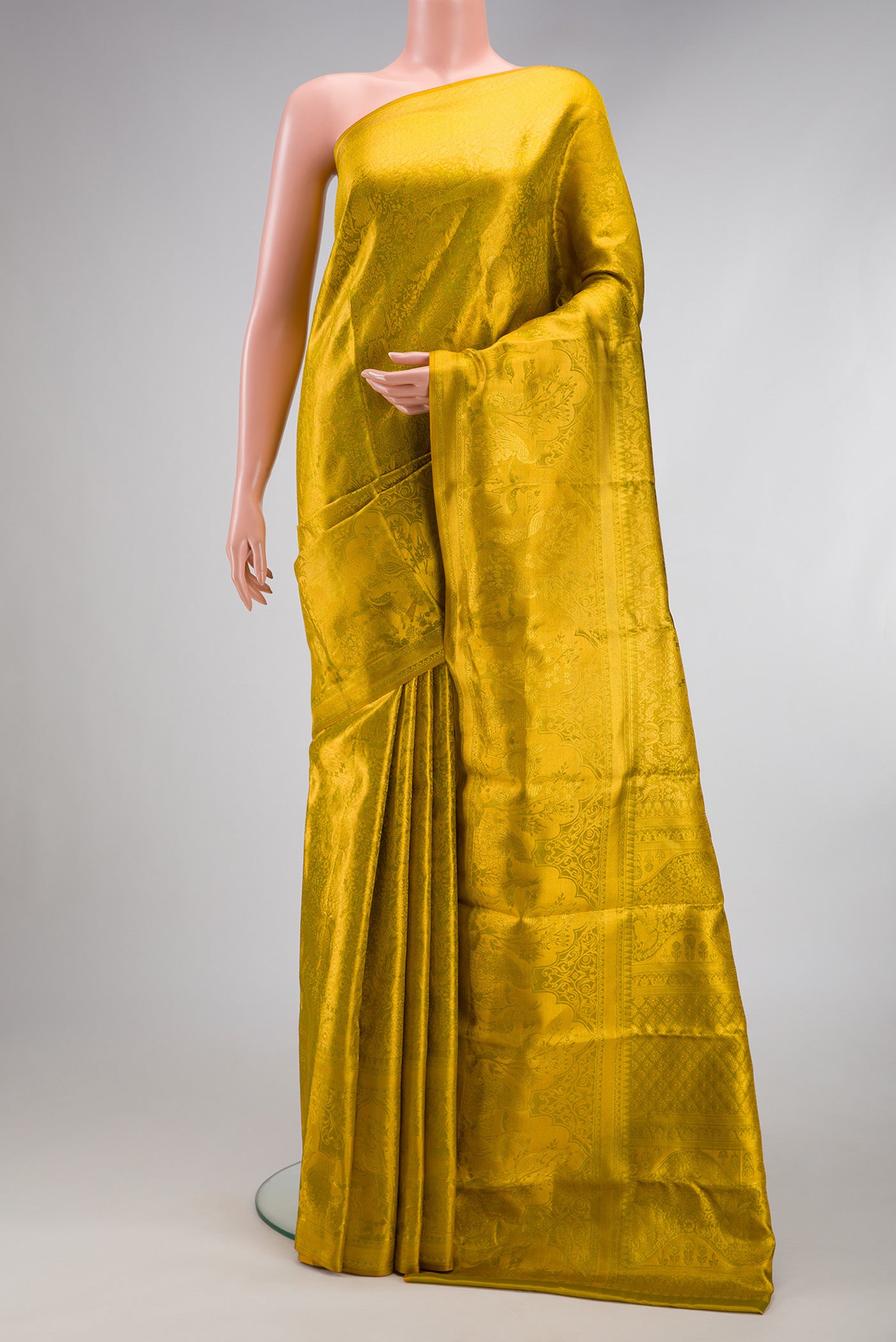 Mehandi Green Dual Tone Kanjivaram Tissue Silk Saree with Zari Brocade on the body and Fancy Border.  displayed on a mannequin