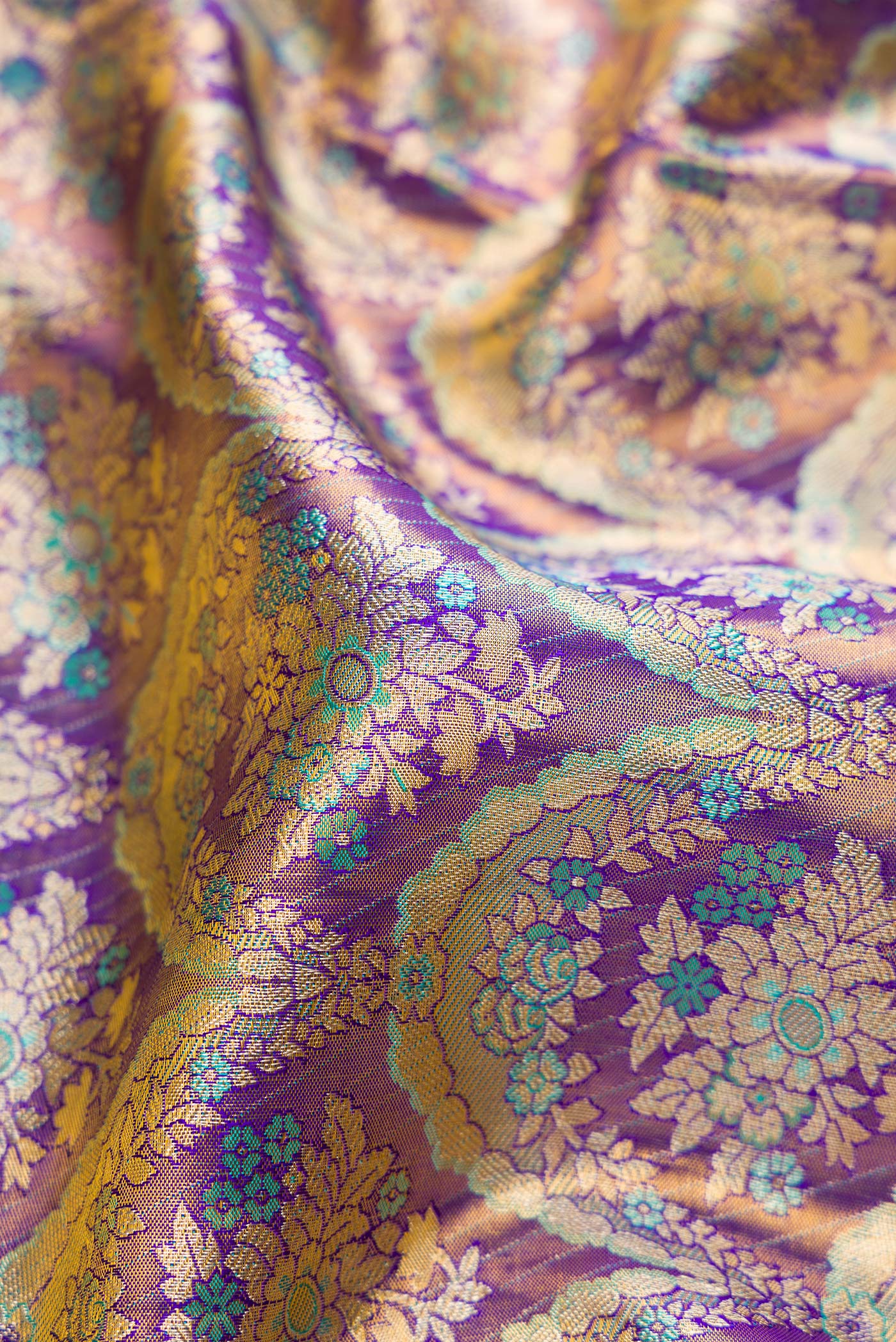 Close up of Royal Blue Dual Tone Kanjivaram Tissue Silk Saree with Zari Brocade on the body and Zari Border.  displaying folds