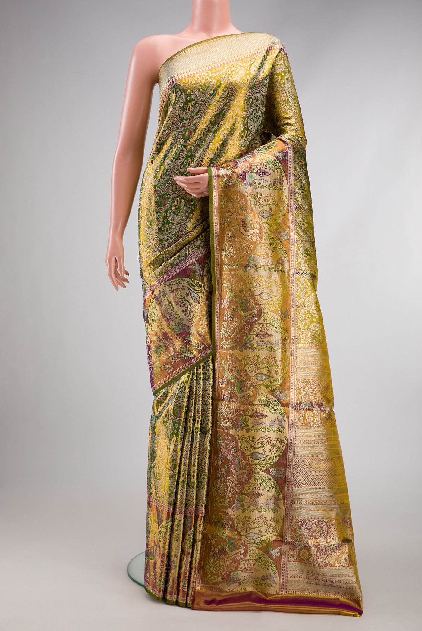 Green Dual Tone Kanjivaram Tissue Silk Saree with Zari Brocade on the body and Fancy Border.  displayed on a mannequin