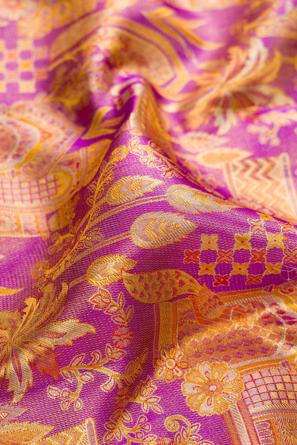 Close up of Purple Dual Tone Kanjivaram Tissue Silk Saree with Zari Brocade on the body and Zari Border.  displaying folds