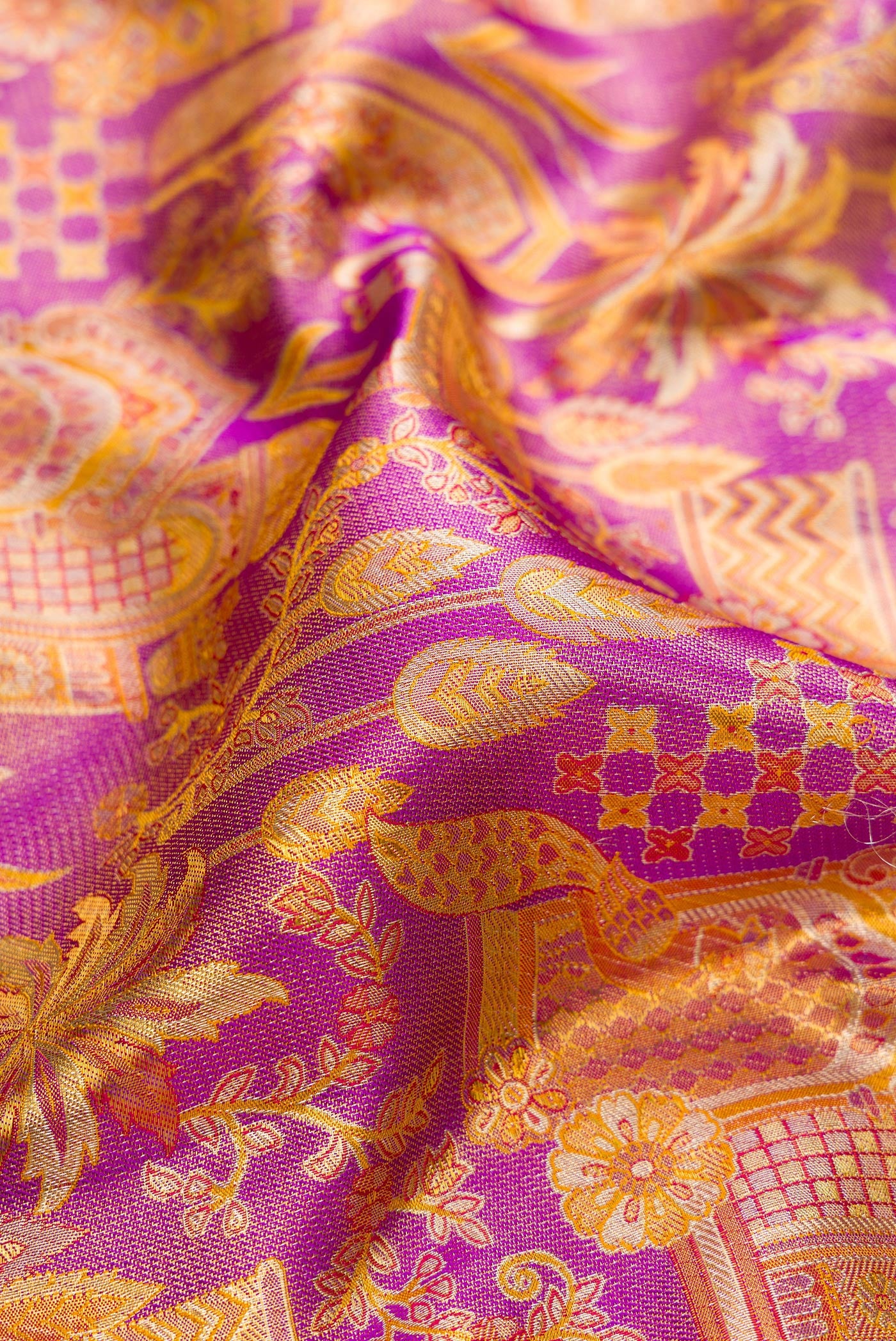 Close up of Purple Dual Tone Kanjivaram Tissue Silk Saree with Zari Brocade on the body and Zari Border.  displaying folds