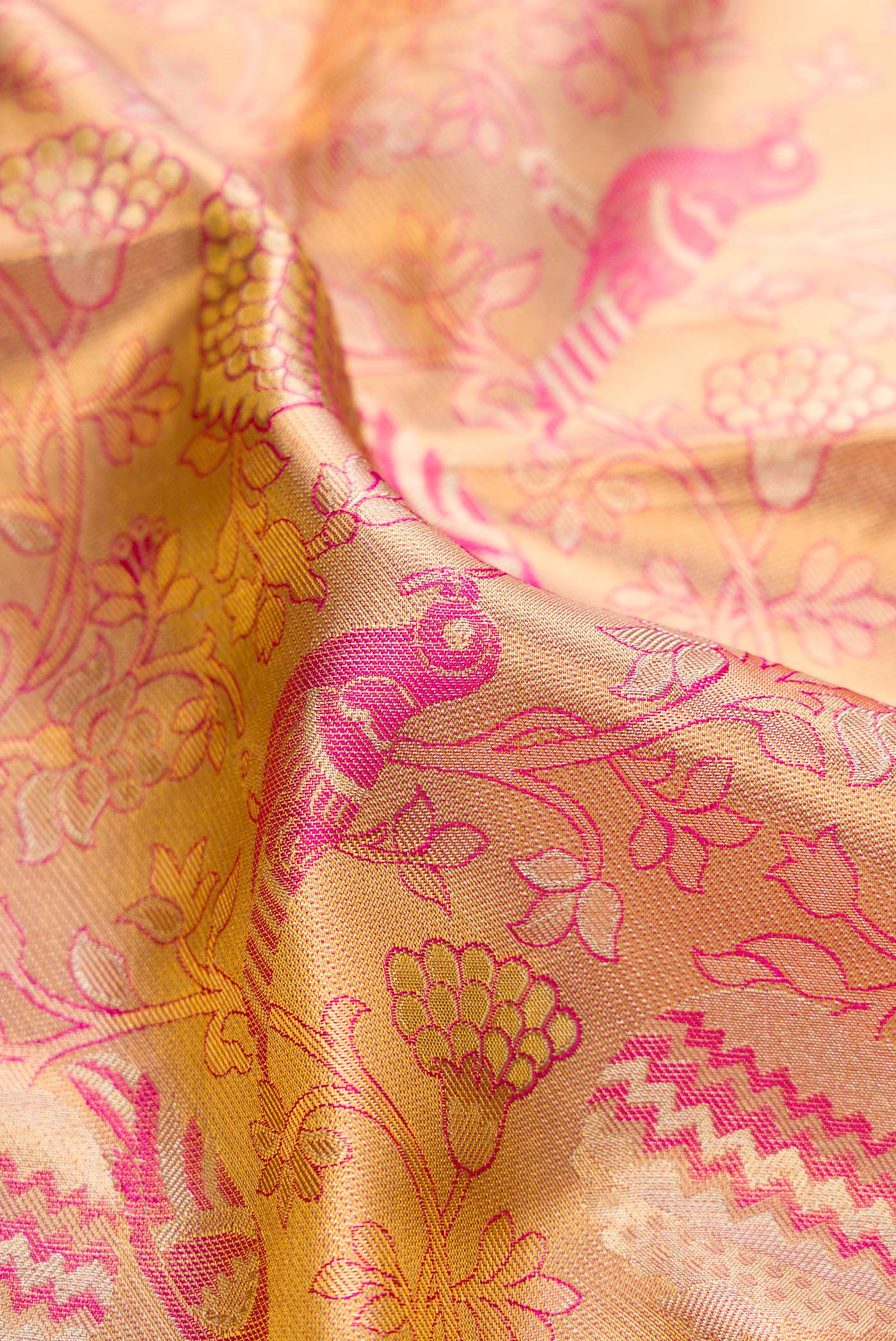 Close up of Pink Dual Tone Kanjivaram Tissue Silk Saree with Zari Brocade on the body and Zari Border.  displaying folds