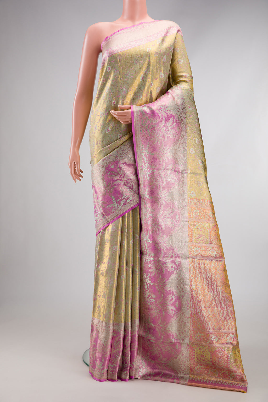 Gold Dual Tone Kanjivaram Tissue Silk Saree with Zari Brocade on the body and Fancy Border.  displayed on a mannequin
