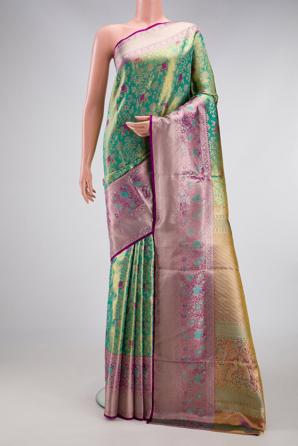 Sea Green Dual Tone Kanjivaram Tissue Silk Saree with Zari Brocade on the body and Zari Border.  displayed on a mannequin