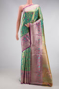 Sea Green Dual Tone Kanjivaram Tissue Silk Saree with Zari Brocade on the body and Zari Border.  displayed on a mannequin