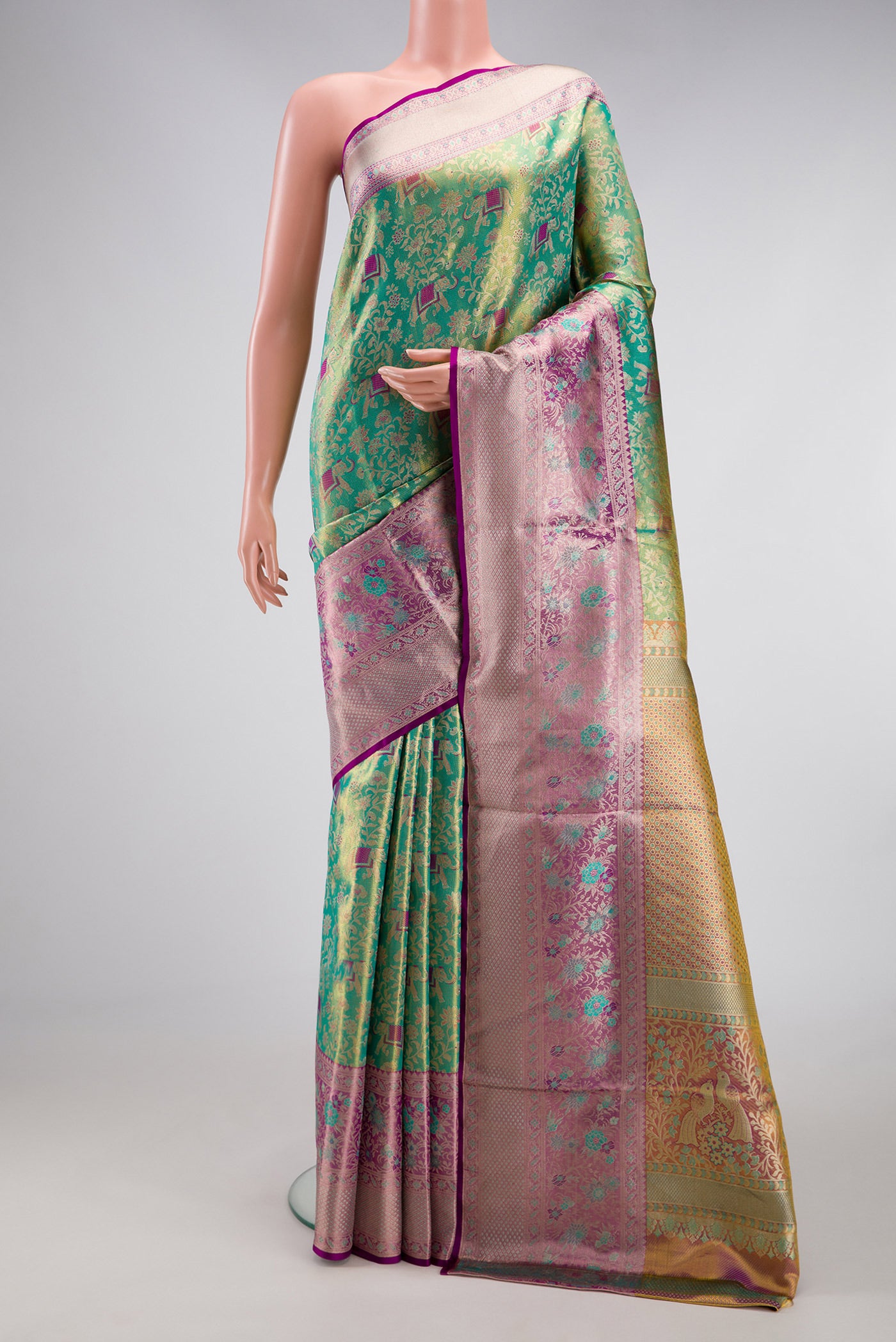 Sea Green Dual Tone Kanjivaram Tissue Silk Saree with Zari Brocade on the body and Zari Border.  displayed on a mannequin