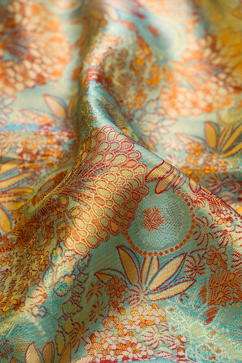 Close up of Blue Dual Tone Kanjivaram Tissue Silk Saree with Zari Brocade on the body and Zari Border.  displaying folds