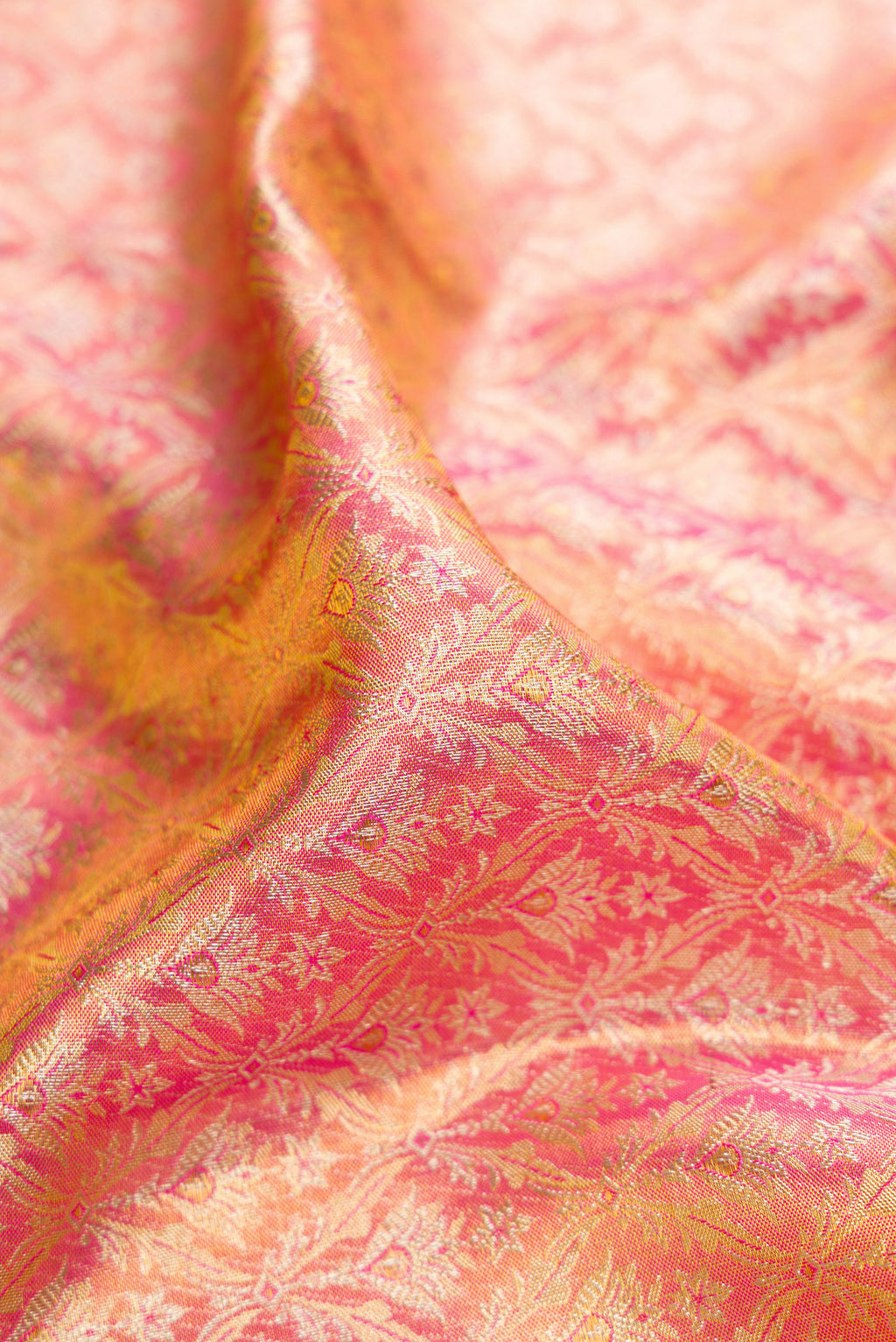 Close up of Pink Dual Tone Kanjivaram Tissue Silk Saree with Zari Brocade on the body and Zari Border.  displaying folds