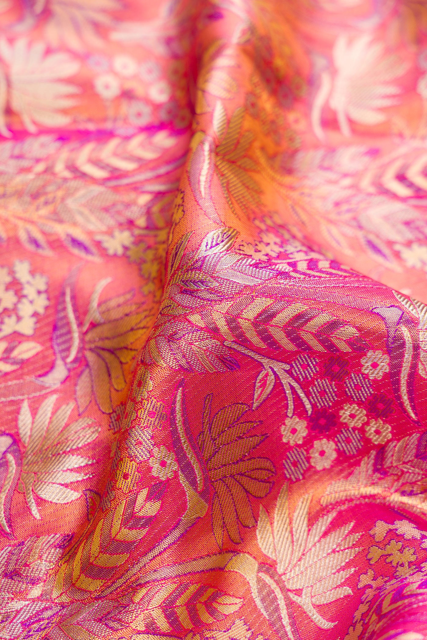 Close up of Pink Dual Tone Kanjivaram Tissue Silk Saree with Zari Brocade on the body and Zari Border.  displaying folds