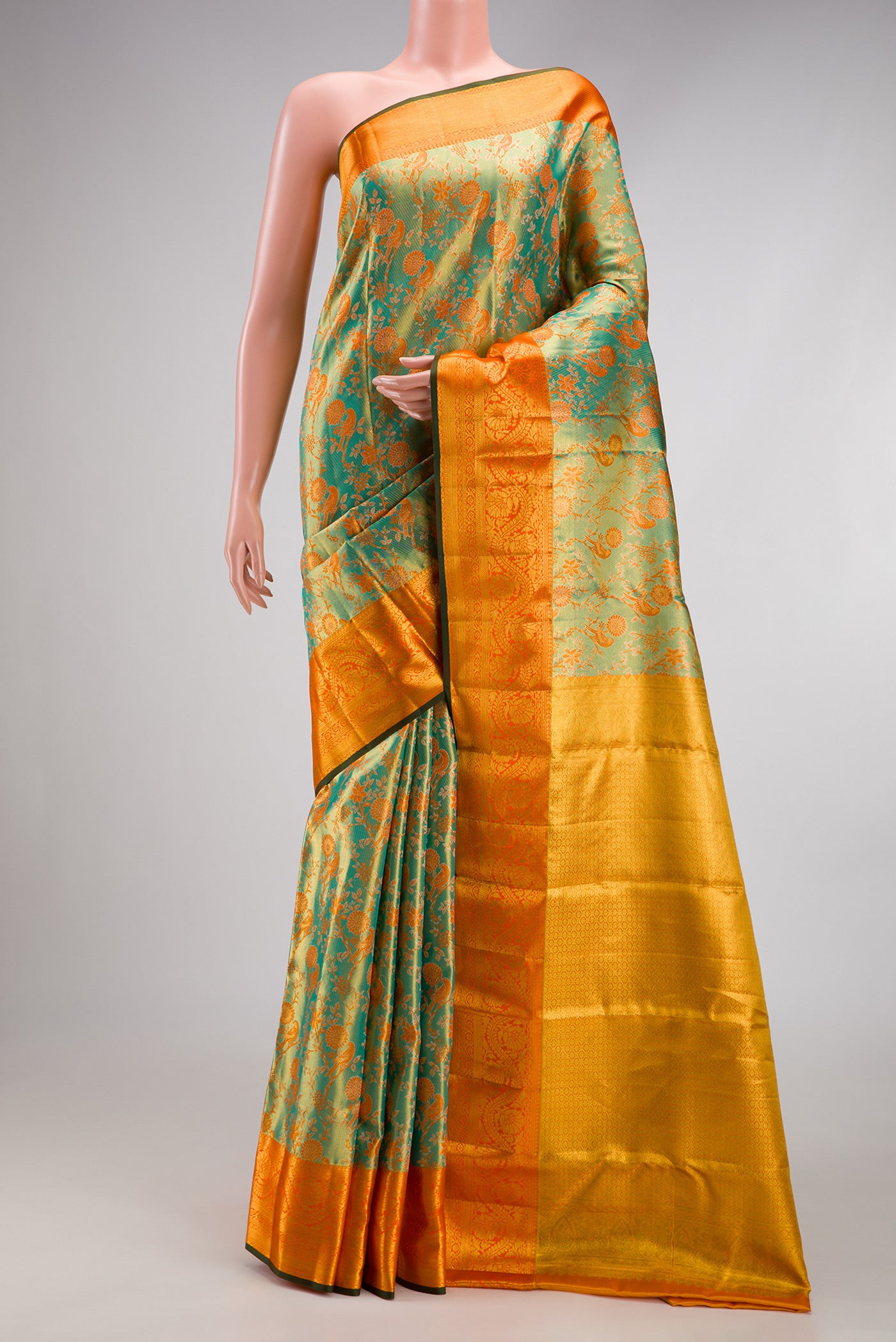 Sea Green Dual Tone Kanjivaram Tissue Silk Saree with Zari Brocade on the body and Zari Border.  displayed on a mannequin