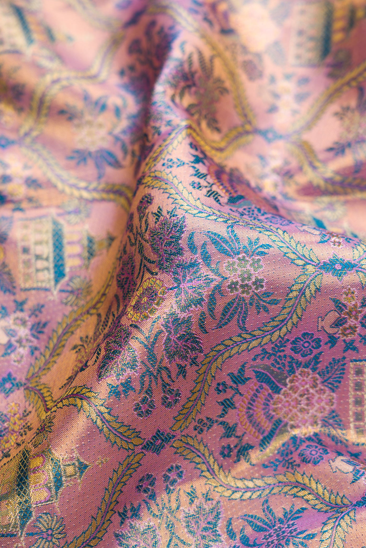 Close up of Lavender Dual Tone Kanjivaram Tissue Silk Saree with Zari Brocade on the body and Zari Border.  displaying folds