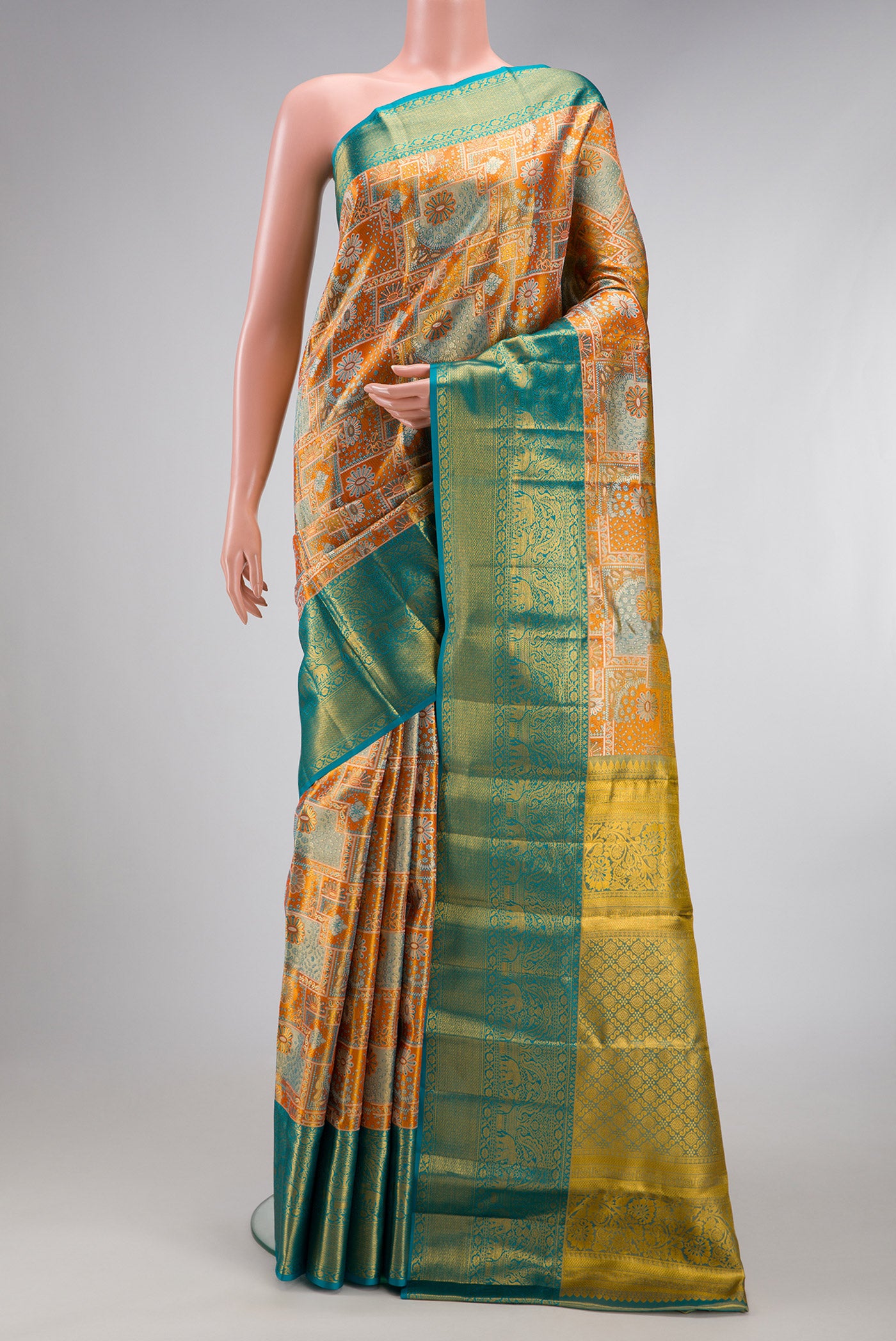 Orange Dual Tone Kanjivaram Tissue Silk Saree with Zari Brocade on the body and Zari Border.  displayed on a mannequin