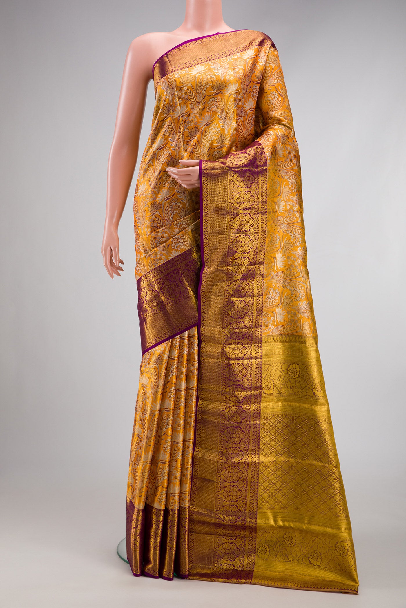 Mustard Dual Tone Kanjivaram Tissue Silk Saree with Zari Brocade on the body and Zari Border.  displayed on a mannequin