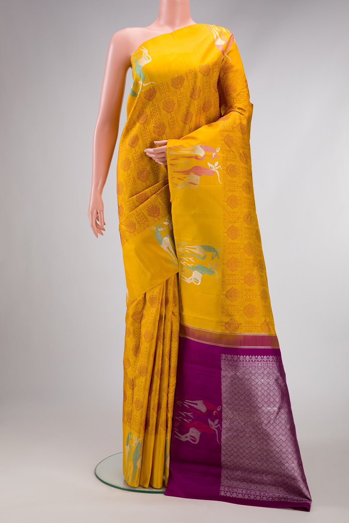 Yellow Dual Tone Kanjivaram Silk Saree with Jacquard design on the body and Fancy Border.  displayed on a mannequin