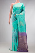 Sea Green Dual Tone Kanchipuram Silk Saree with Jacquard design on the body and Fancy Border.  displayed on a mannequin