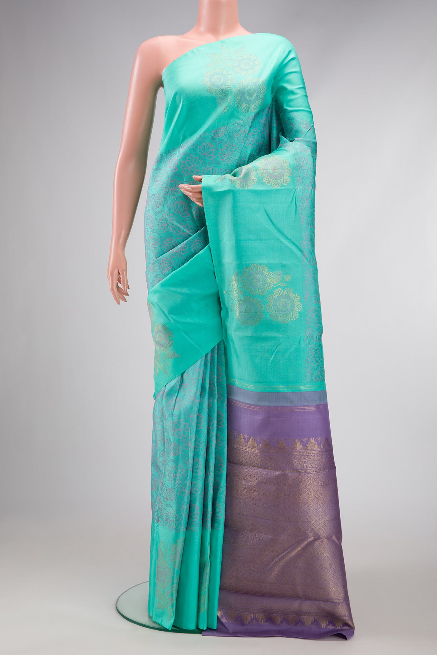 Sea Green Dual Tone Kanchipuram Silk Saree with Jacquard design on the body and Fancy Border.  displayed on a mannequin