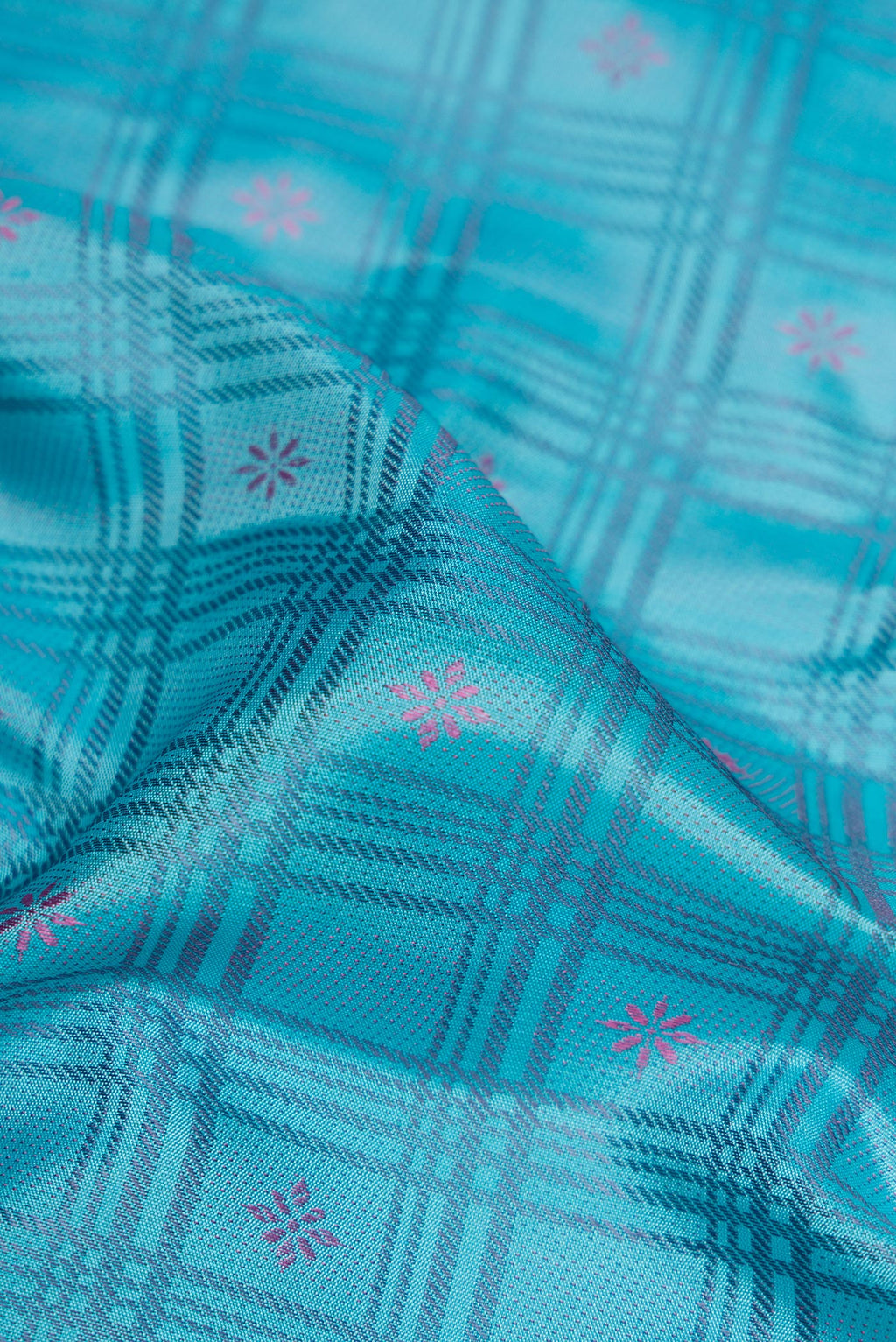 Close up of Sky Blue Dual Tone Kanchipuram Silk Saree with Checked design on the body and Fancy Border.  displaying folds