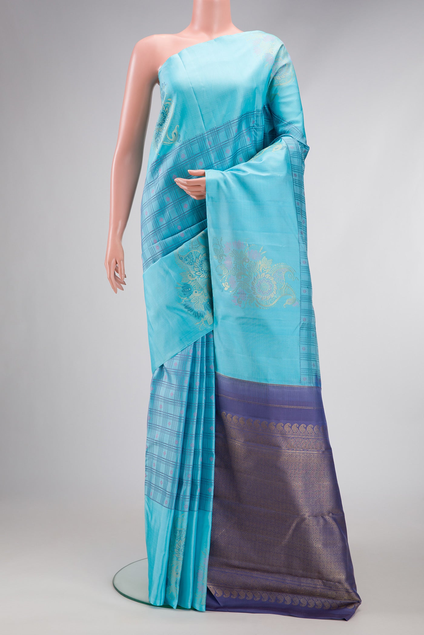 Sky Blue Dual Tone Kanchipuram Silk Saree with Checked design on the body and Fancy Border.  displayed on a mannequin