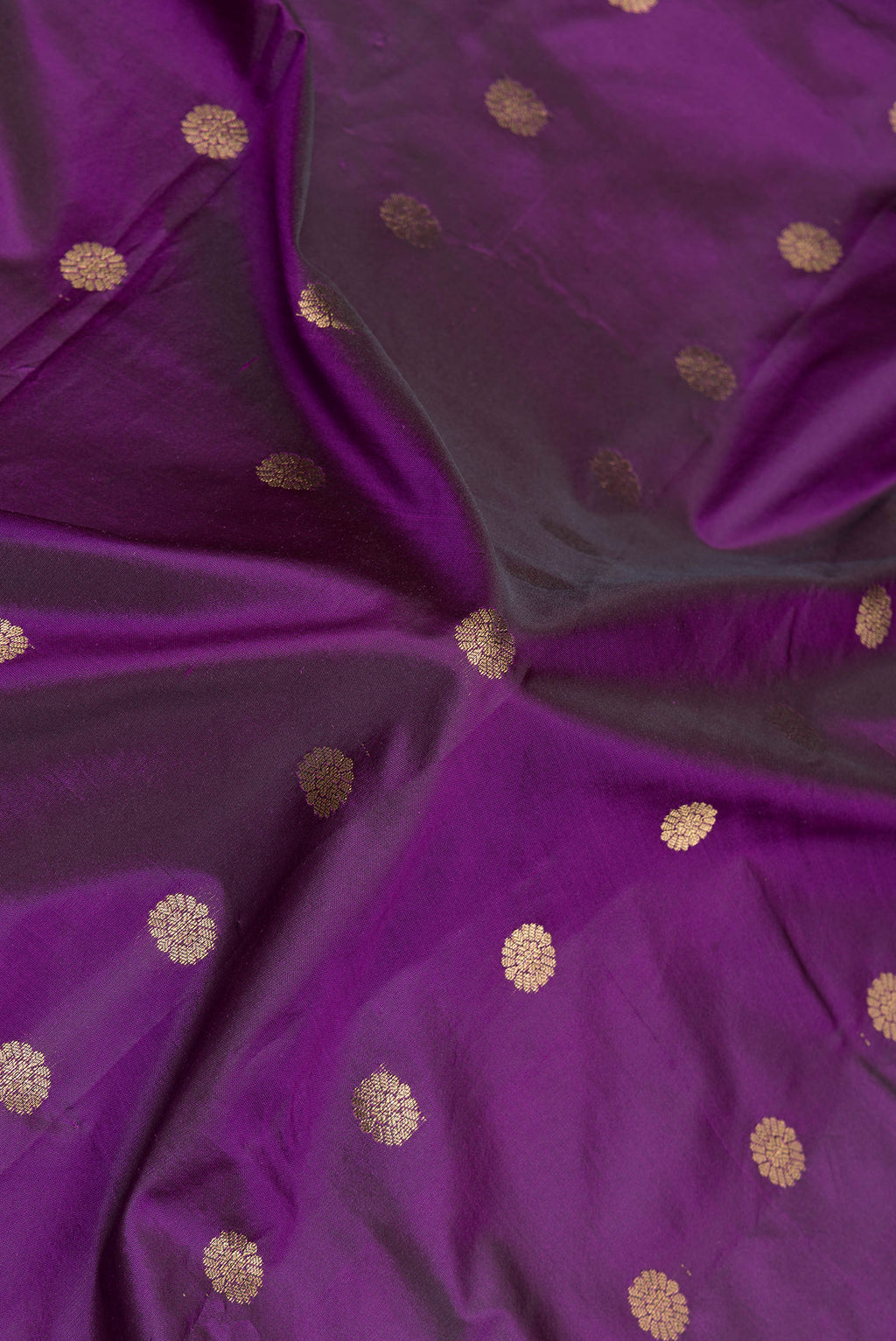 Close up of Violet Paithani Silk Saree with Zari Butta on the body and Zari Border.  displaying folds