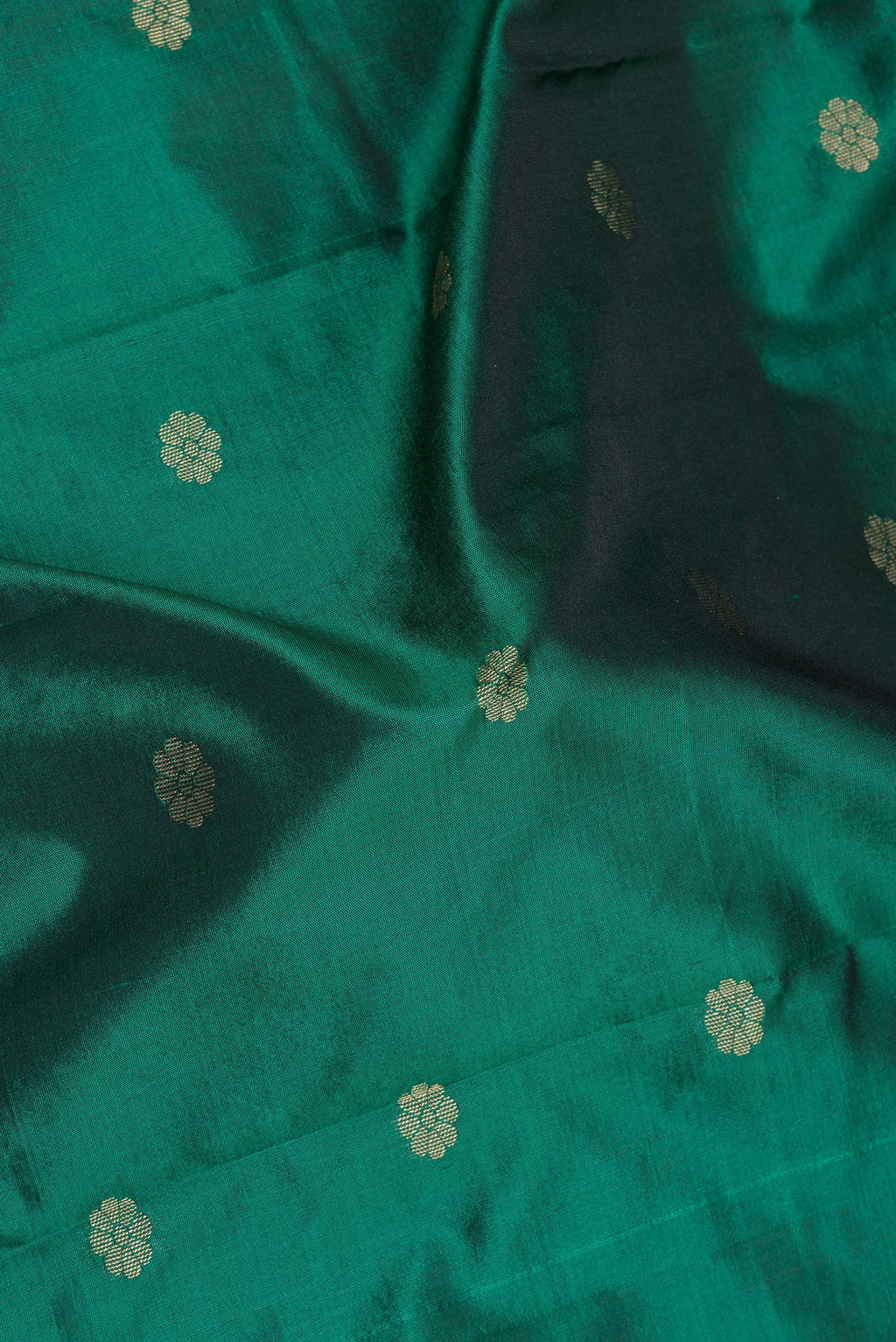 Close up of Bottle Green Blended Paithani Silk Saree with Zari Butta on the body and Zari Border.  displaying folds
